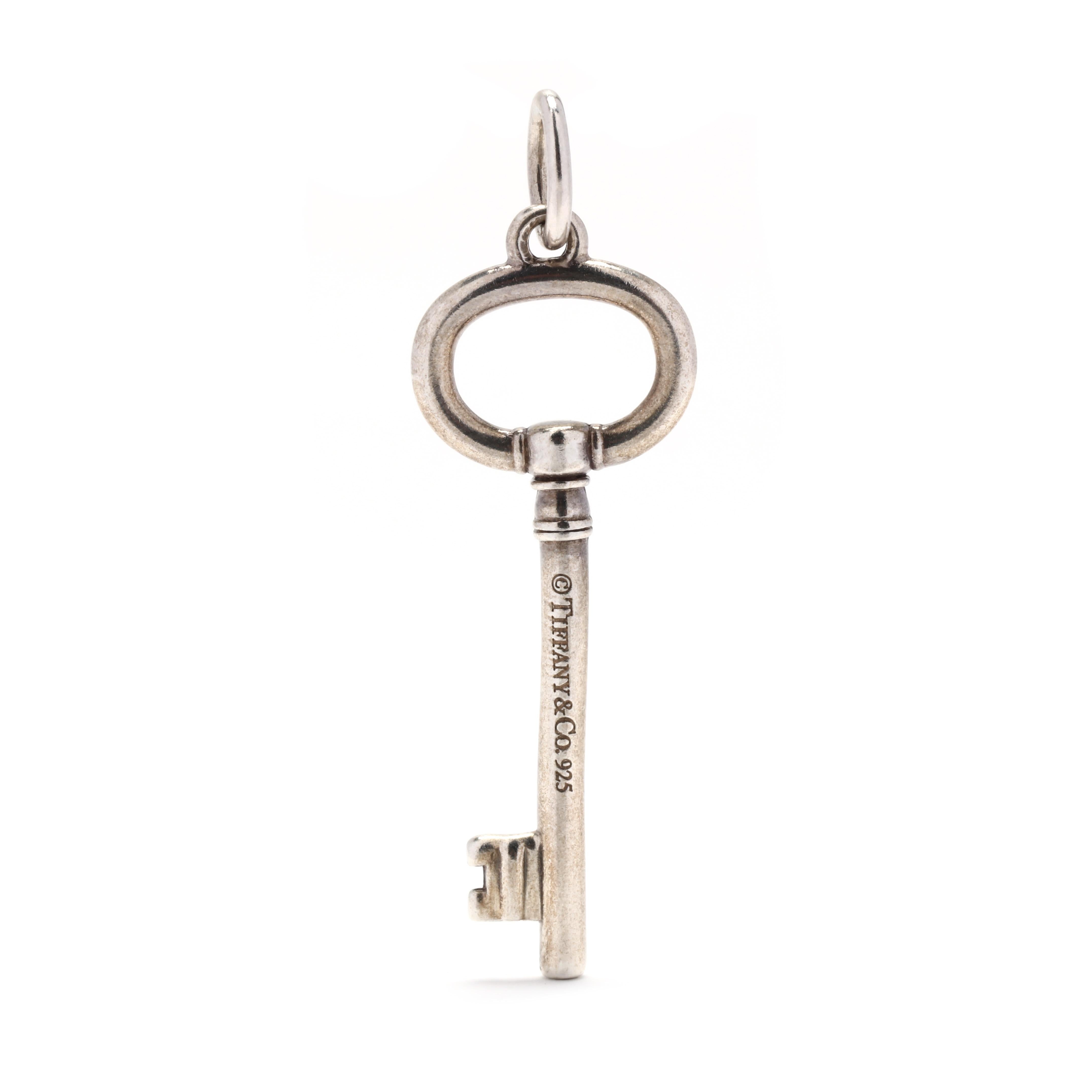 A Tiffany & Company sterling silver key charm. This pendant features a simple key motif with a polished finish.



Length: 1.5 in.



Width: 1/2 in.



Weight: 2.1 grams