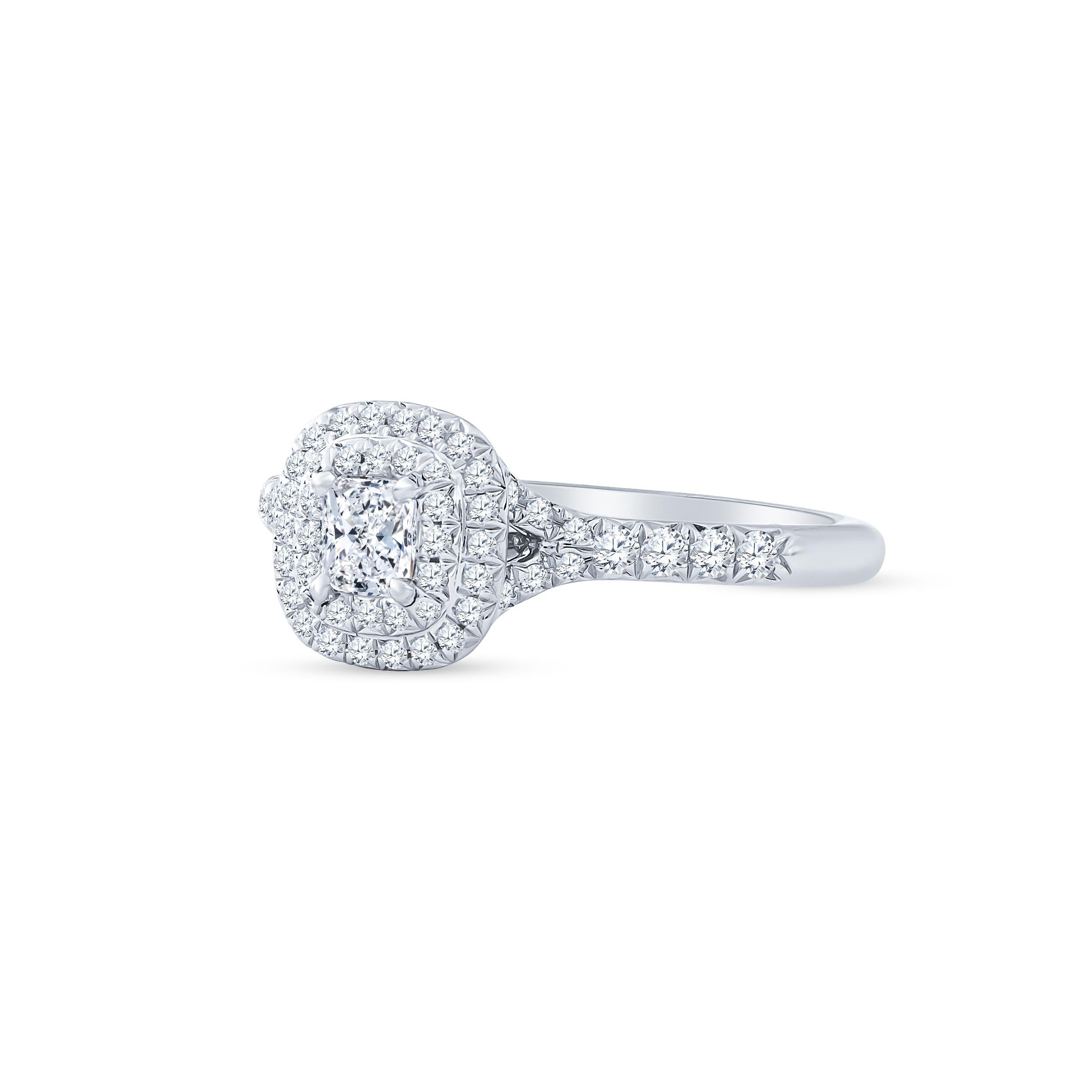 Dazzling Tiffany & Co. Soleste engagement ring that features a fine 0.24 carat cushion cut diamond that is beautifully surrounded by 0.32 carats of round brilliant cut diamonds set in double halo form and upper shoulders of the band. The ring was