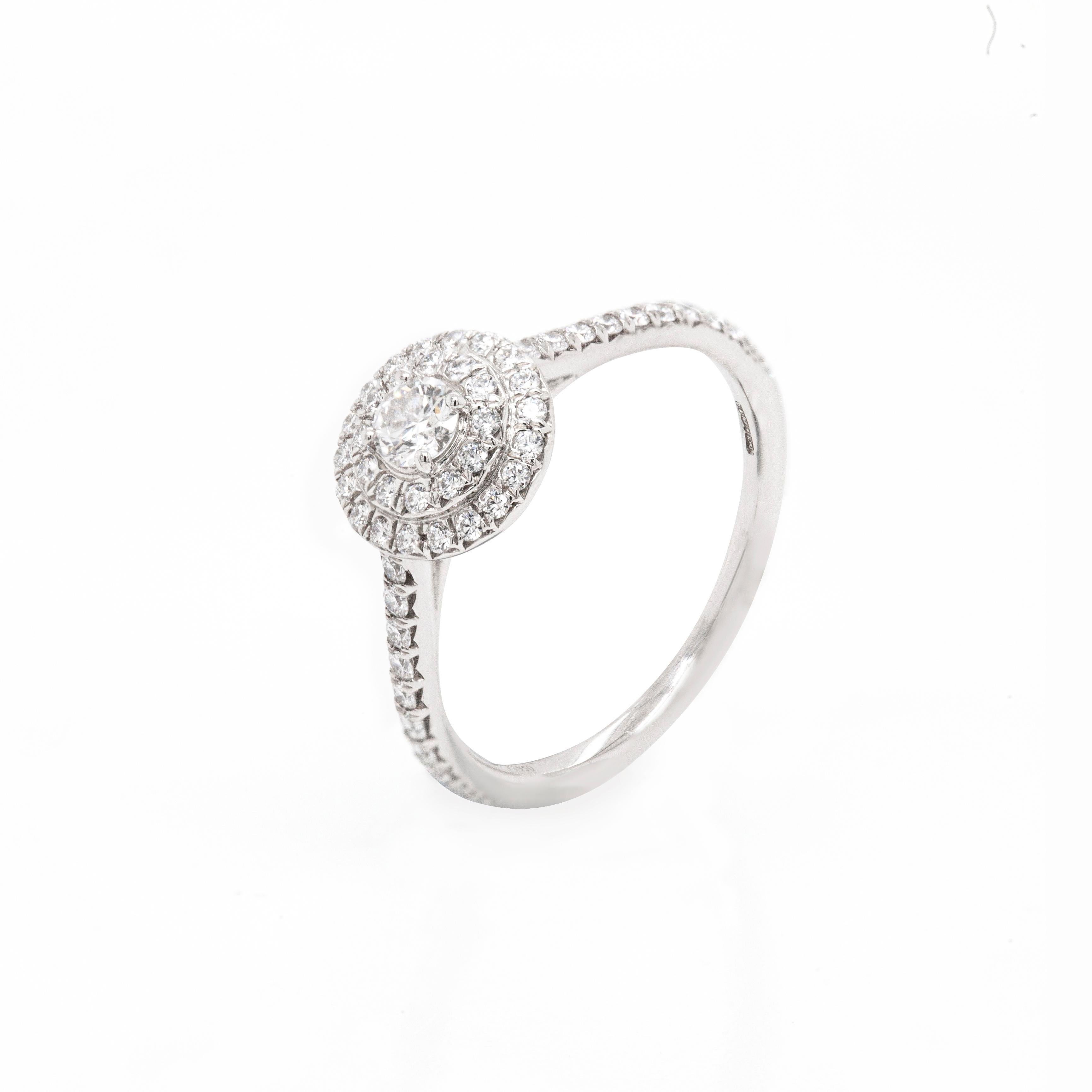 This wonderful engagement ring by the famous luxury house, Tiffany & Co. from their iconic 'Soleste' Collection is masterfully crafted from platinum. A beautiful 0.15ct round brilliant cut diamond mounted in a four claw, open back setting,