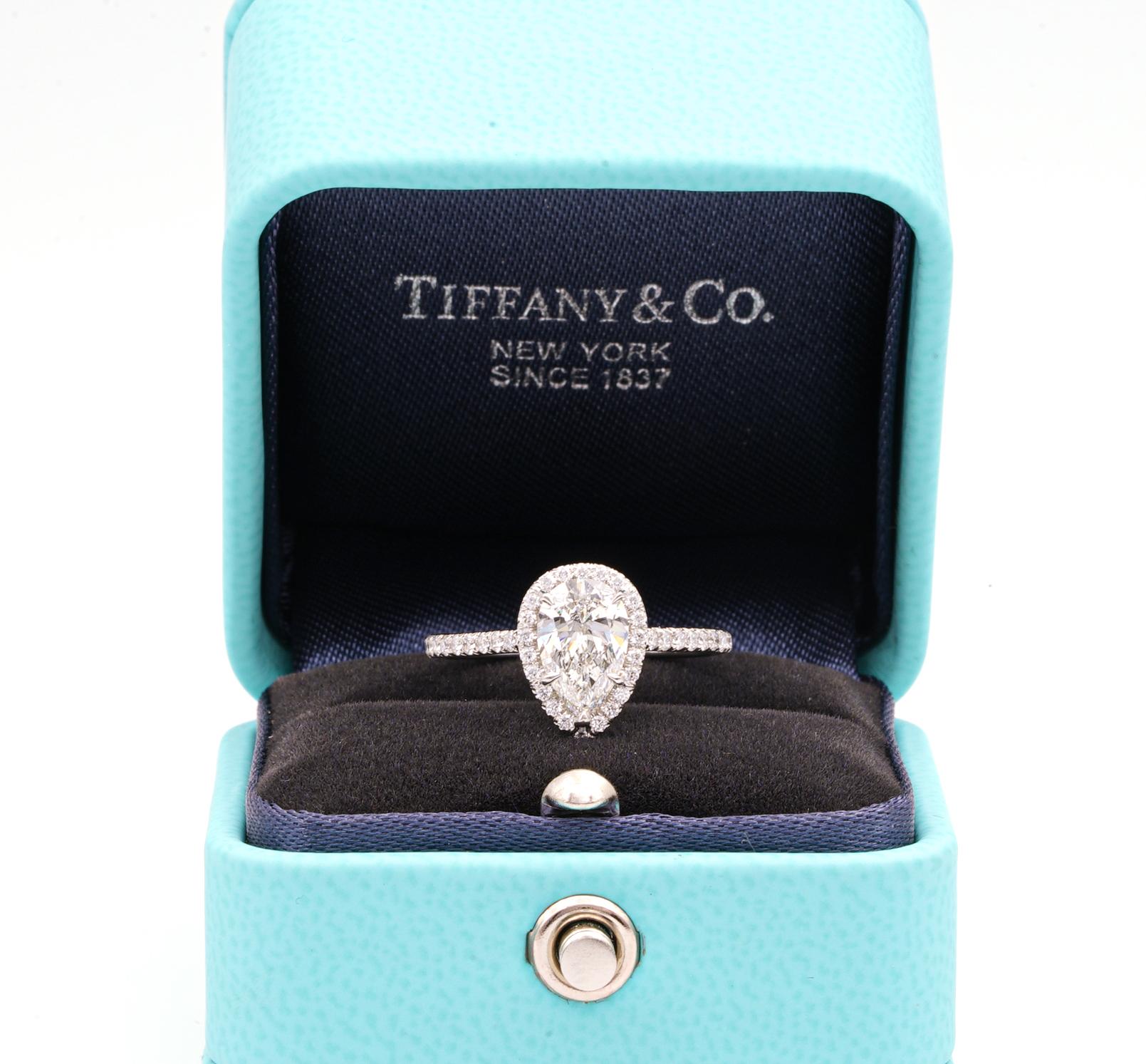 Tiffany & Co. Soleste Diamond Engagement ring featuring a 1.10 ct Pear Shape Center diamond finely crafted in Platinum, accented by a bead set diamond halo and shank with 42 round brilliant cut diamonds weighing 0.40 cts. total weight