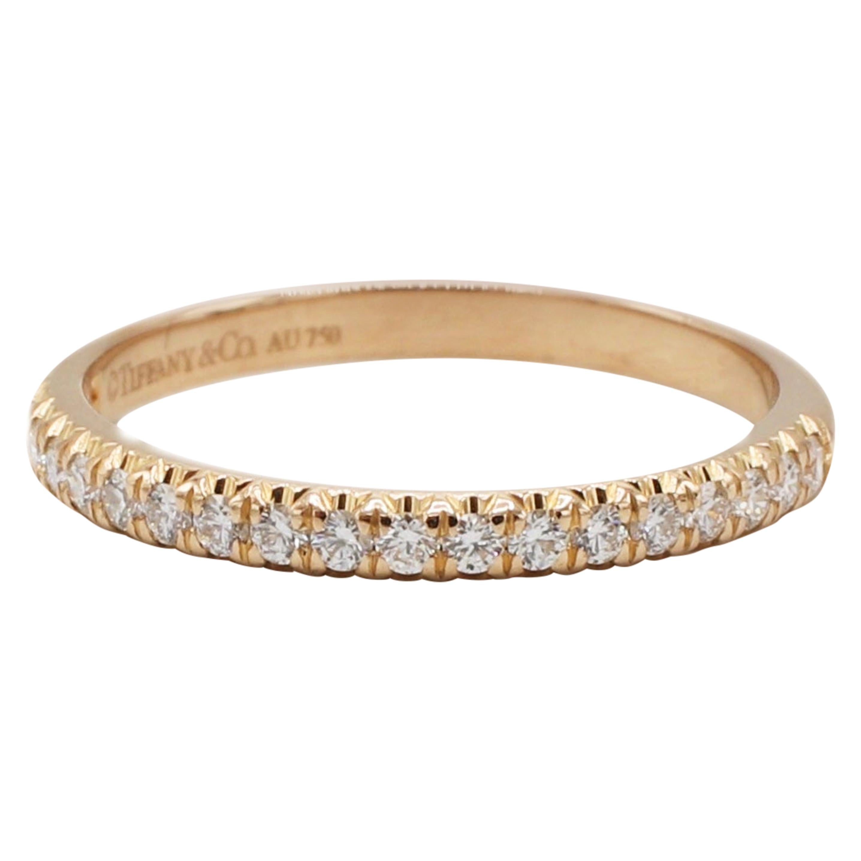 Tiffany & Co. Soleste 18 Karat Rose Gold Half Circle Diamond Band Ring Size 5

Metal: 18k rose gold
Weight: 2.01 grams
Diamonds: 20 round diamonds, approx. .17 CTW F-G VS
Size: 5 (US)
Band is 2mm wide
Signed: Tiffany & Co. Au750 

Retail: $2,200
