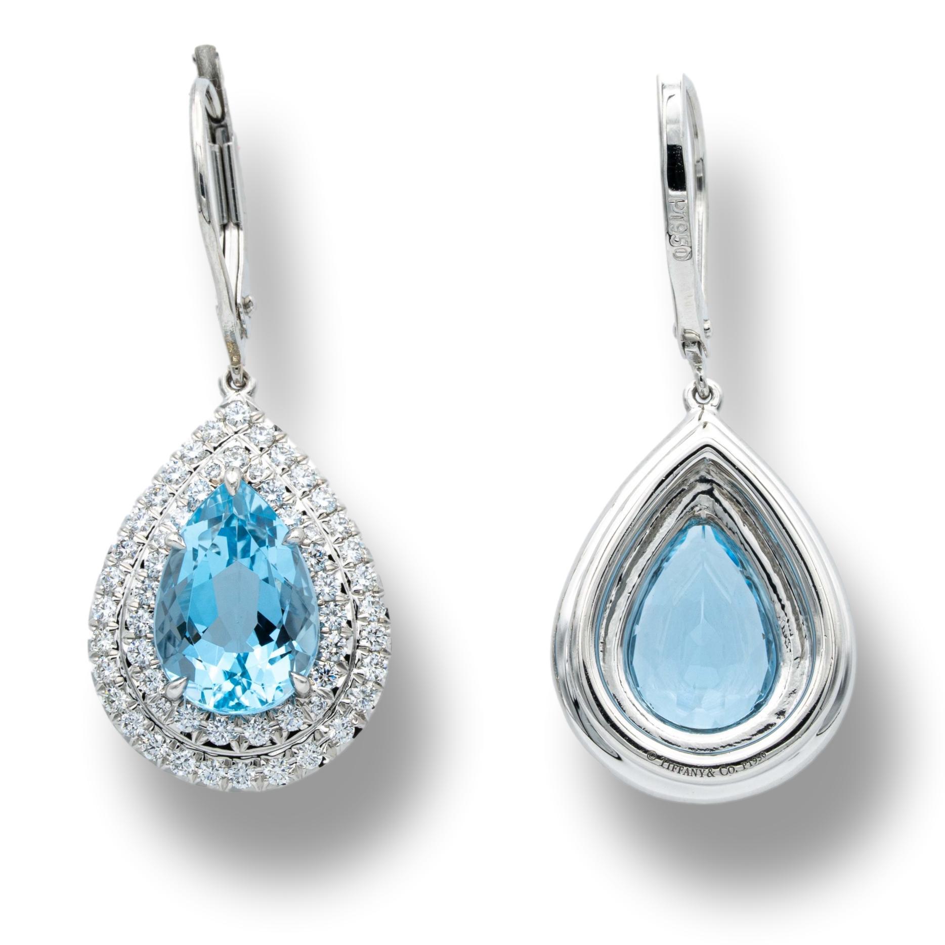Tiffany & Co. Soleste Aquamarine and Diamond Earrings finely crafted in platinum with pear shape fine quality aquamarines weighing 3.00 carats total surrounded by a double halo of round brilliant cut diamonds weighing .58 carats total weight. The