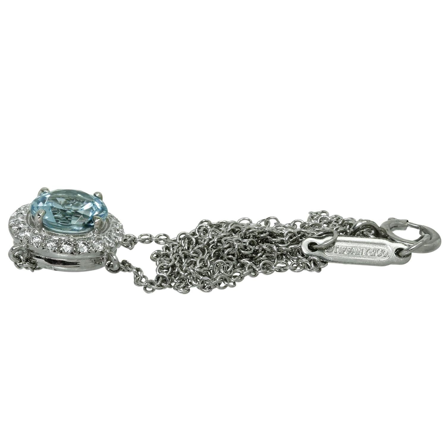 This gorgeous Tiffany & Co. necklace from the sophisticated Soleste collection is crafted in platinum and features a round pendant set with a blue aqumarine weighing an estimated 0.70 carats surrounded with brilliant-cut round diamonds weighing an