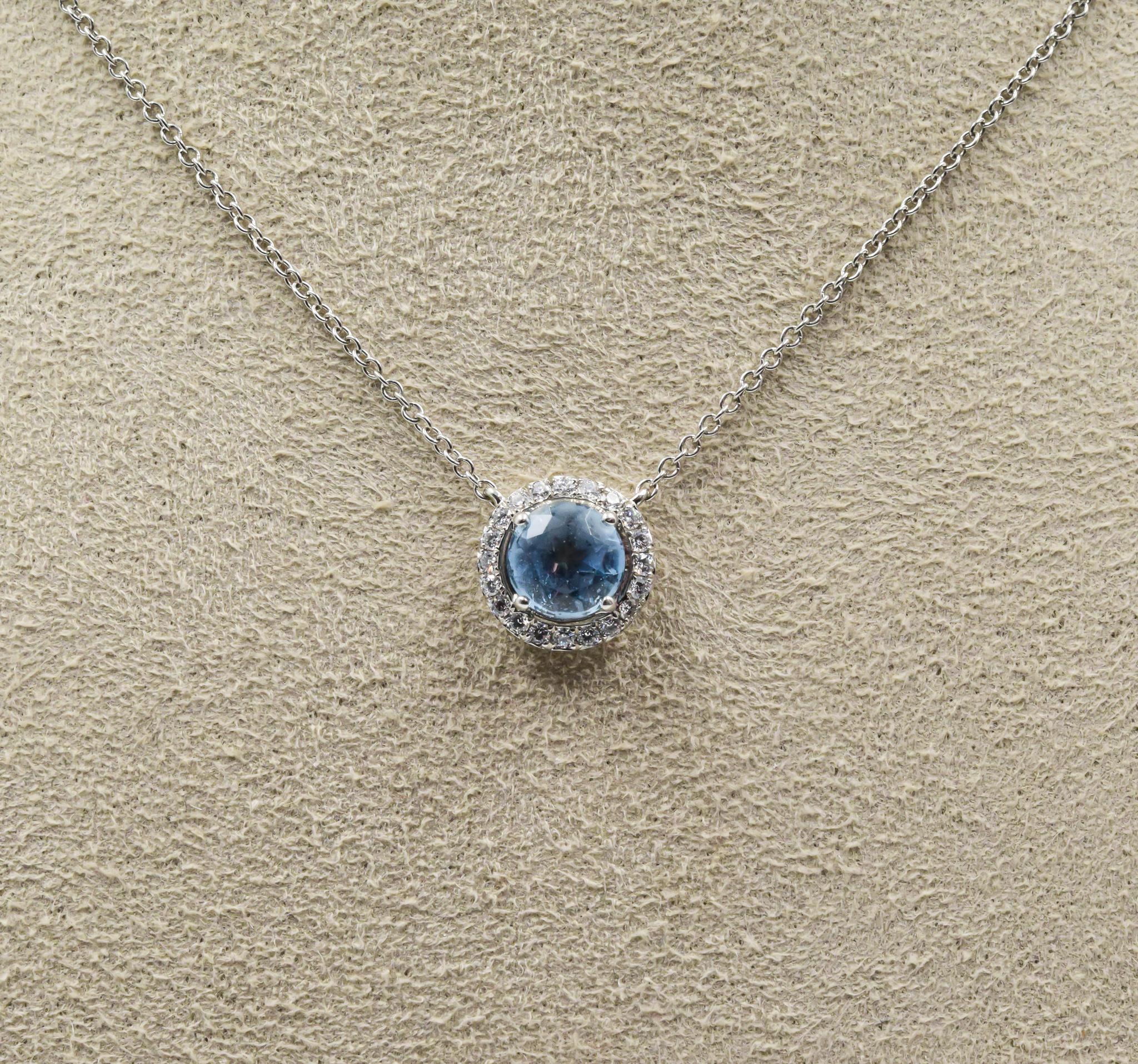 This Tiffany & Co. pendant was recently traded in and is in excellent condition with the box.  This pendant is in platinum with a .50 carat round Aquamarine center gemstone accented by a halo of round brilliant diamonds totaling 0.11 carats.  This
