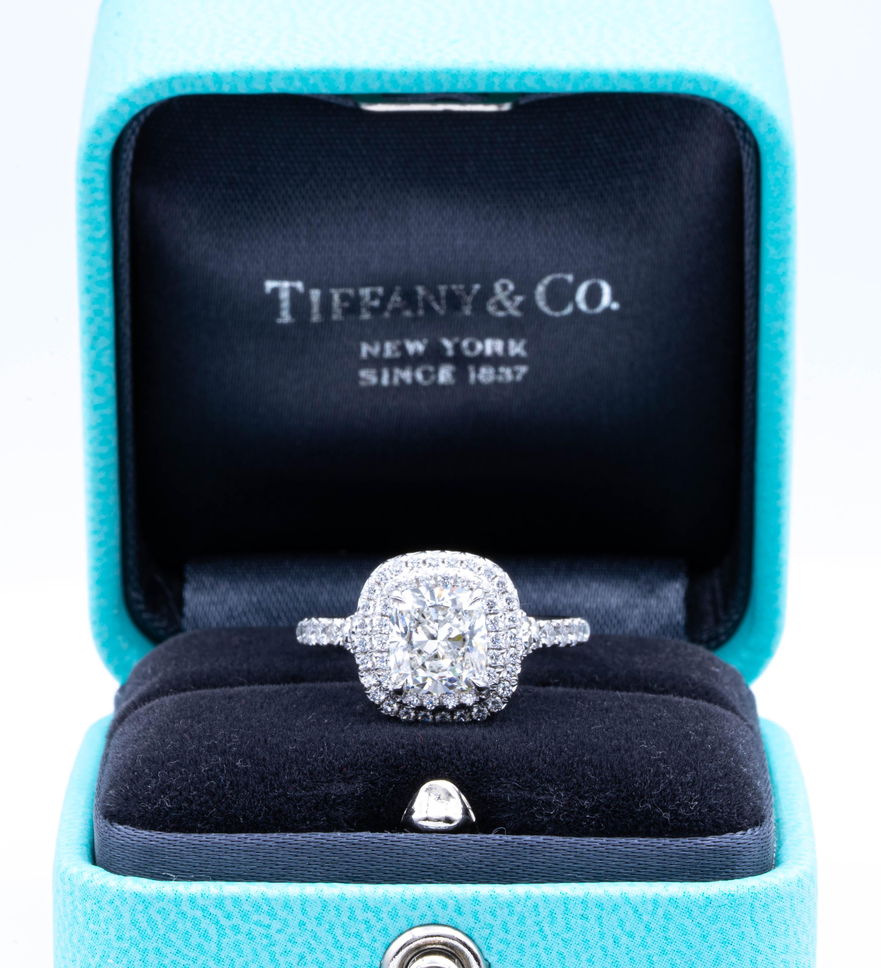 Tiffany & Co. Soleste engagement ring with a 1.38 ct cushion center , H Color, VS1 clarity finely crafted in platinum, accented by a double row halo design with round brilliant cut bead set diamonds weighing 0.30 carats approximately in the D-F