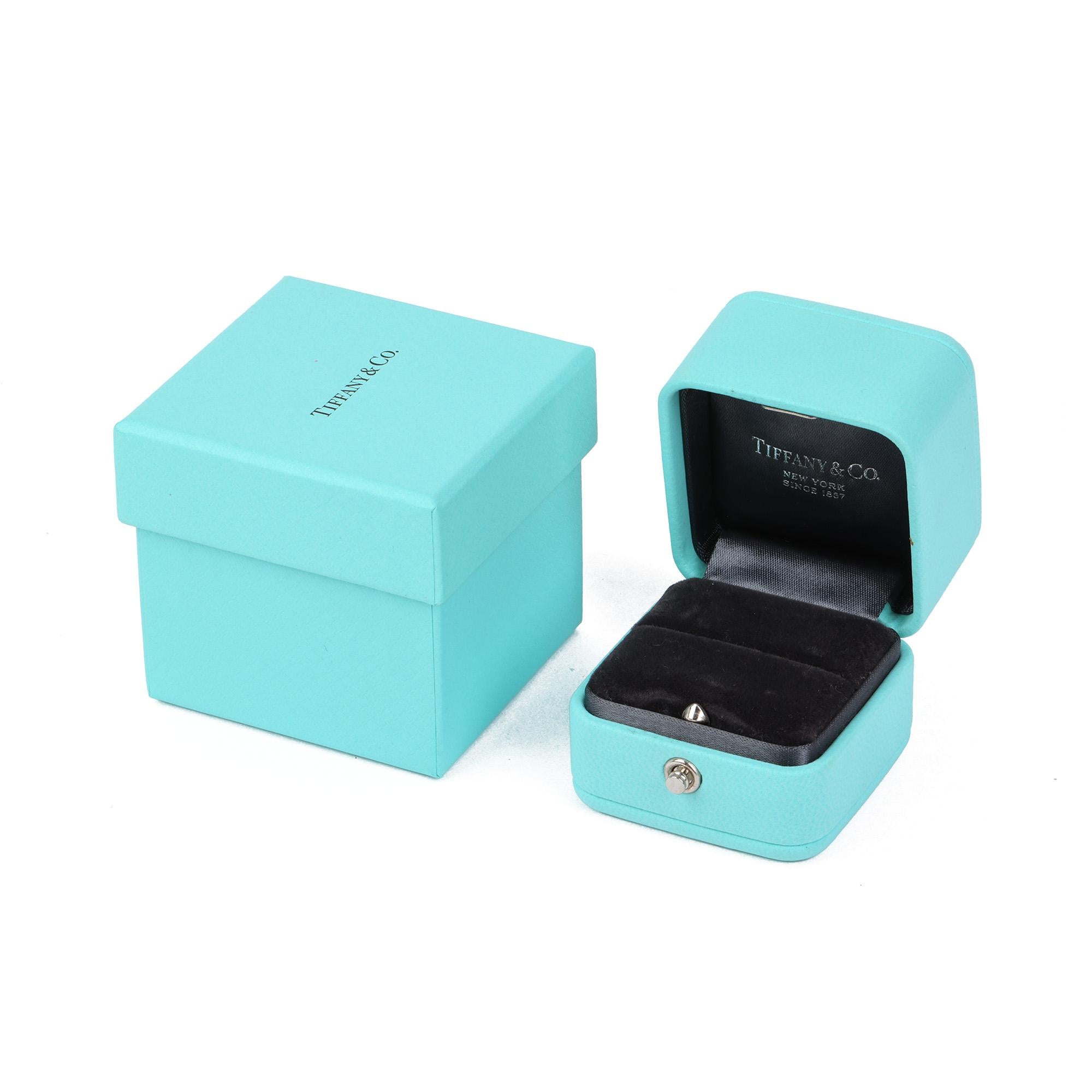 This engagement ring by Tiffany & Co is from their Soleste collection and features 1 cushion cut diamond totalling 0.18ct surrounded by a halo of additional diamonds with additional diamonds on the shoulders. Accompanied by a Tiffany & Co. box and