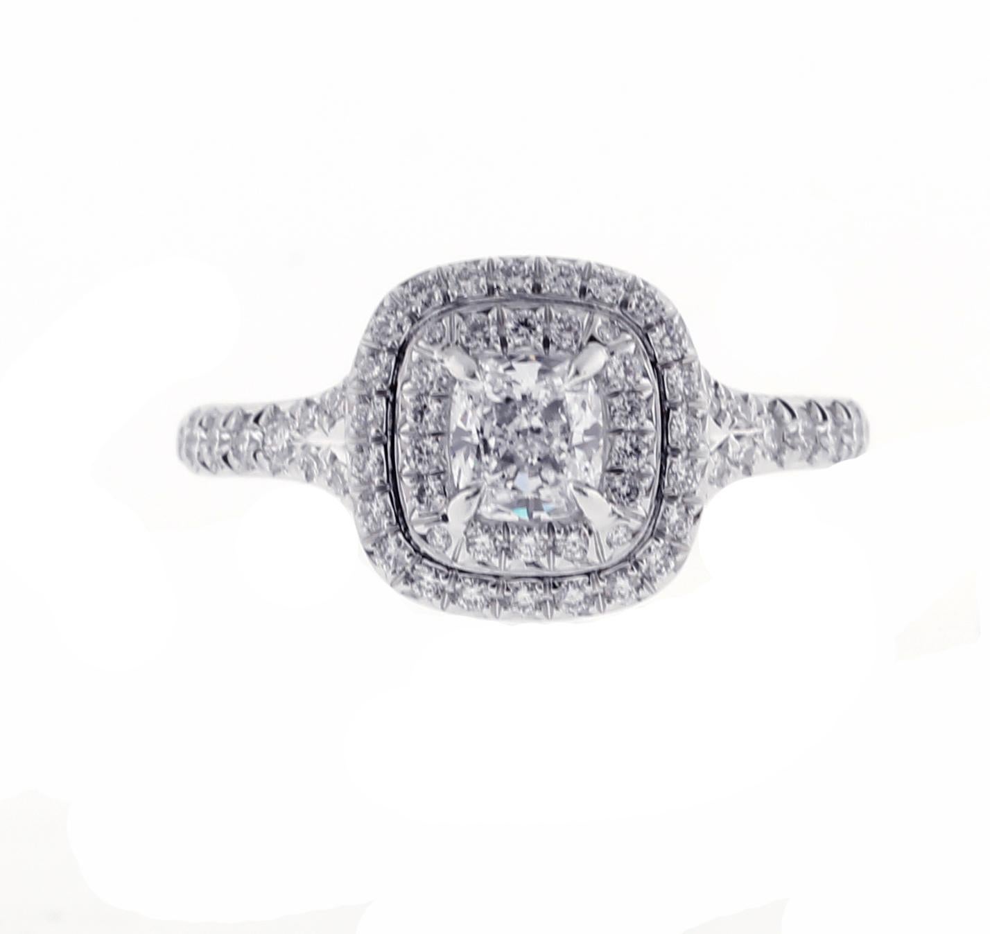 Tiffany Soleste engagement ring. With a scintillating double halo of brilliant diamonds and a striking cushion-cut center stone, light is gathered and mirrored throughout the design, resulting in an unrivaled display of brilliance. Both the ring and