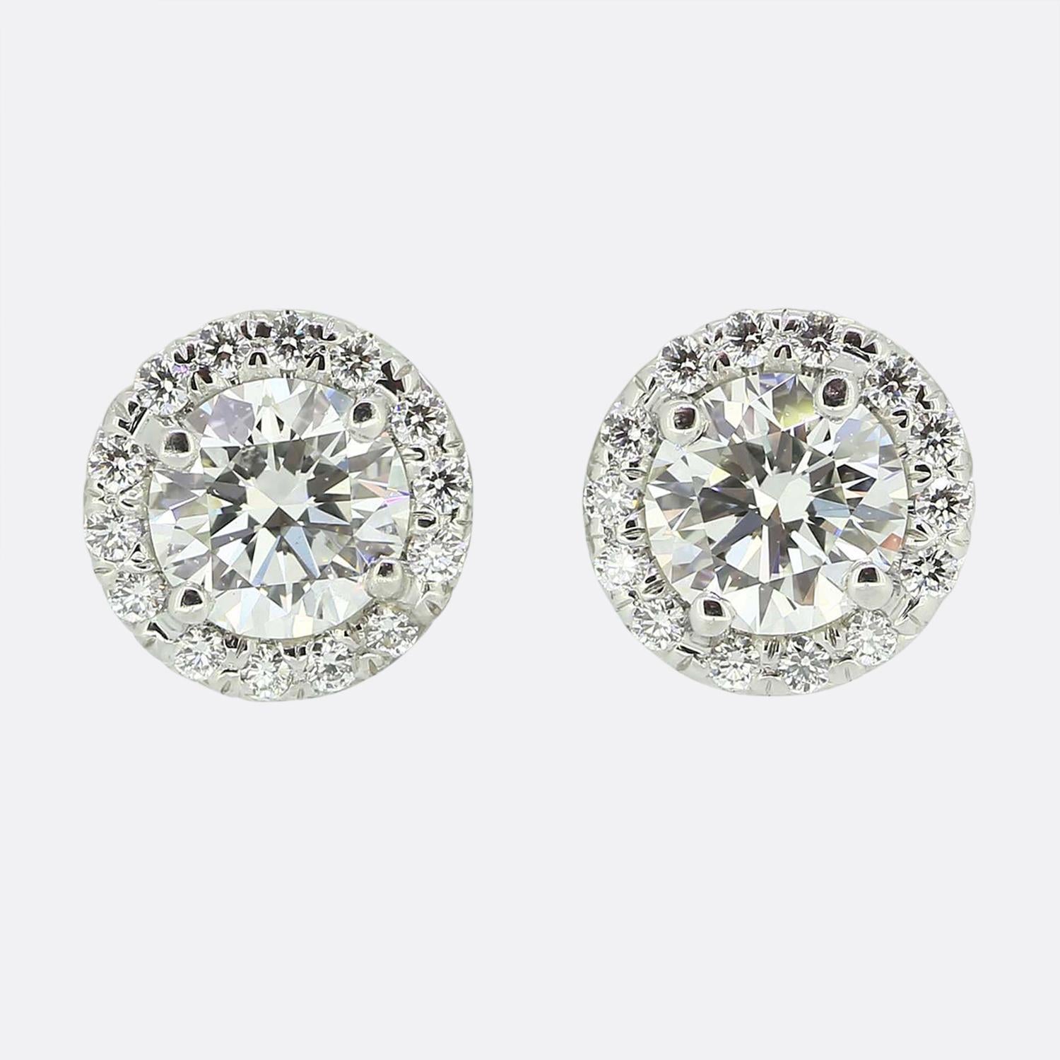 Here we have a fabulous diamond necklace and stud earrings set from the world renowned jewellery designer Tiffany & Co. Both pieces form part of the 'Soleste' collection and feature a single round brilliant cut diamond framed by a halo of matching