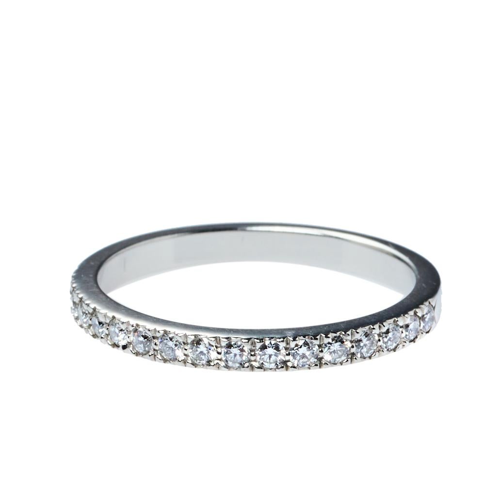Seal the bond of love with this Half eternity wedding band ring from the house of Tiffany & Co. Designed from a platinum body, this ring features diamonds embedded over half of the shank. We love the simplicity and elegance of this ring that can be