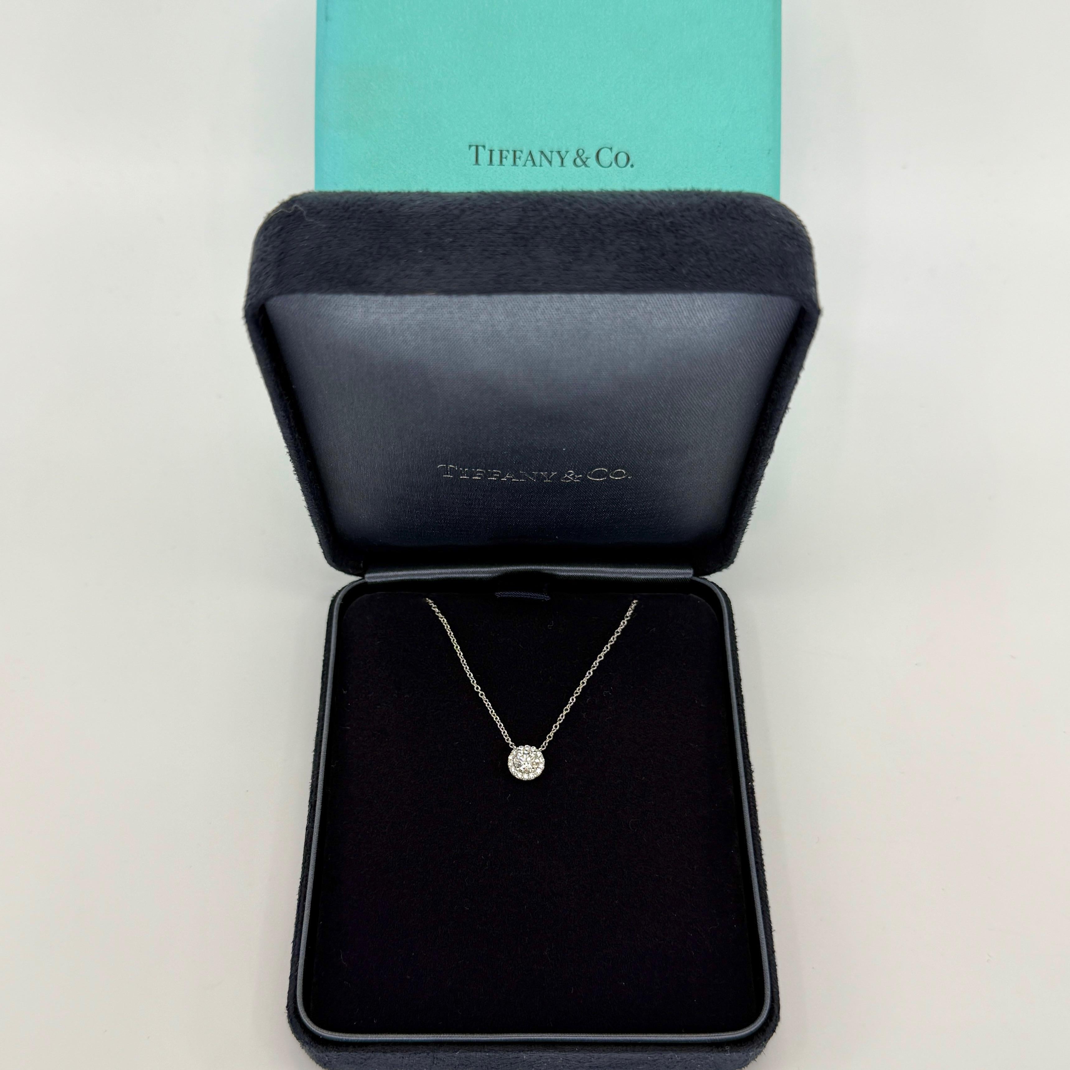 Vintage Tiffany & Co. Soleste Round Cut Natural Diamond Halo 950 Platinum Necklace. Approx. 0.51 carat total.

A beautiful platinum pendant necklace from the Tiffany & Co Soleste range.
Featuring a 4.7mm central diamond (approx. 0.37 carat) with