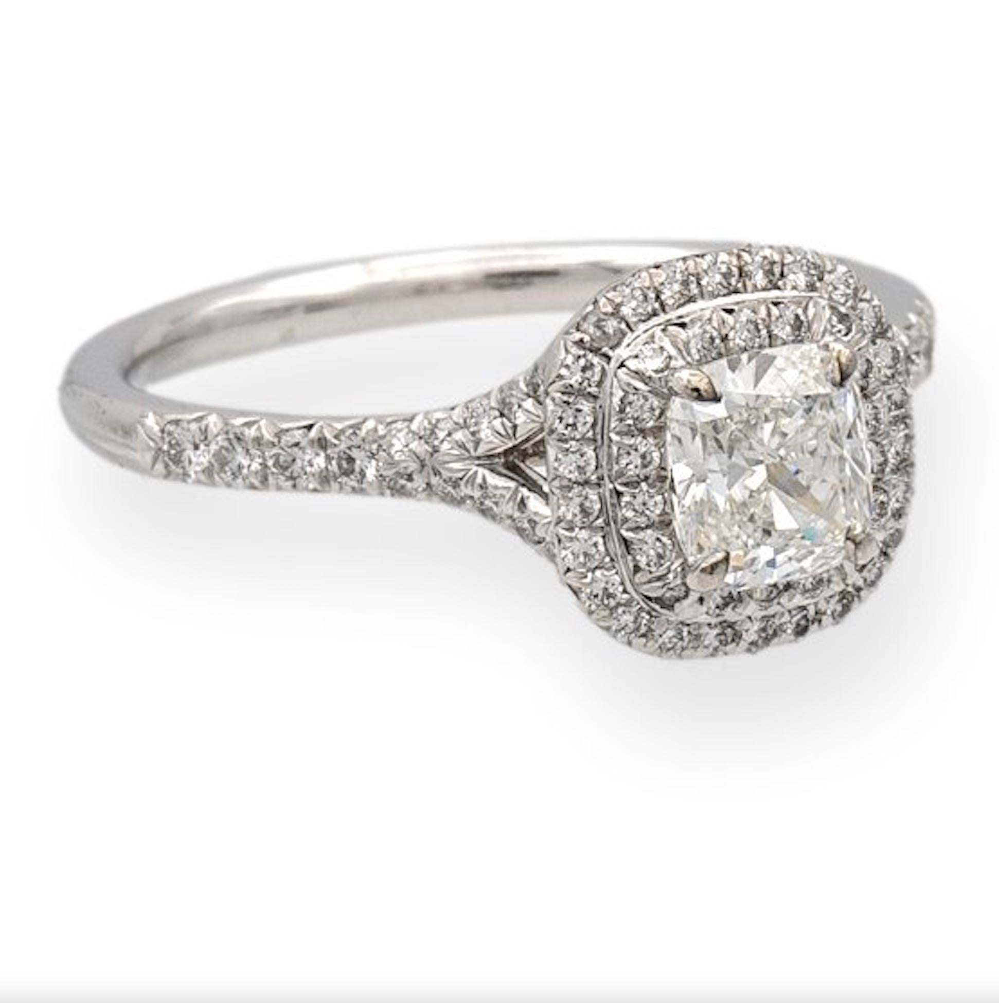Tiffany & Co. engagement ring from the Soleste collection featuring a .78 ct cushion center , F Color, VVS2 clarity finely crafted in platinum, accented by a double row halo and split shank design with round brilliant cut bead set diamonds weighing