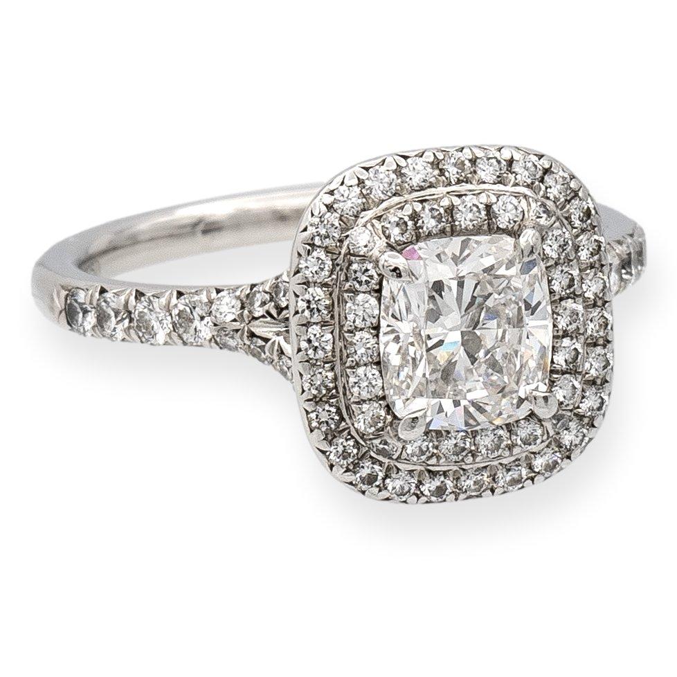 Tiffany & Co. engagement ring from the Soleste collection finely crafted in platinum featuring a .94 carat cushion center , H Color, VS1 clarity center , accented by round brilliant cut bead set diamonds weighing 0.35 carats approximately inside a