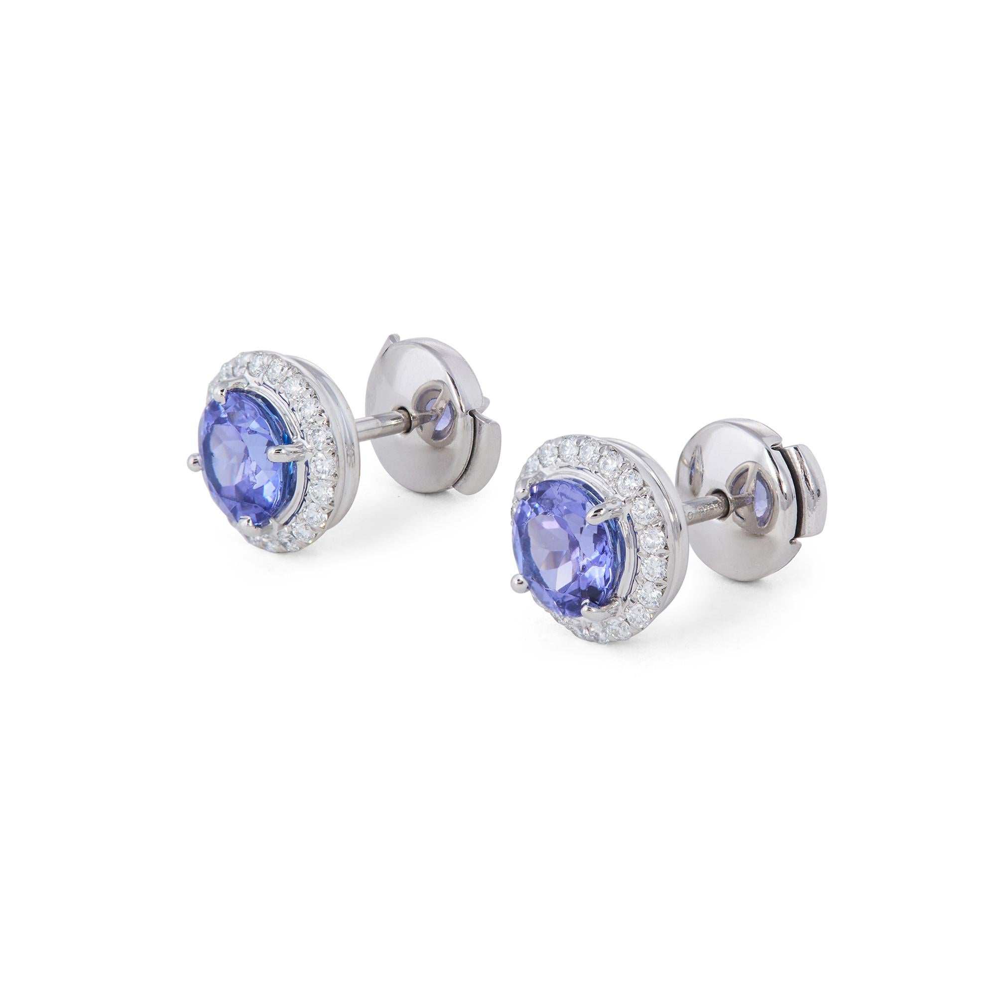 Authentic Tiffany & Co. 'Soleste' earrings each center on a round tanzanite stone weighing approximately 1.20ct surrounded by high quality round brilliant cut diamonds of an estimated 0.19 carats. Signed Tiffany & Co., PT950. The earrings are