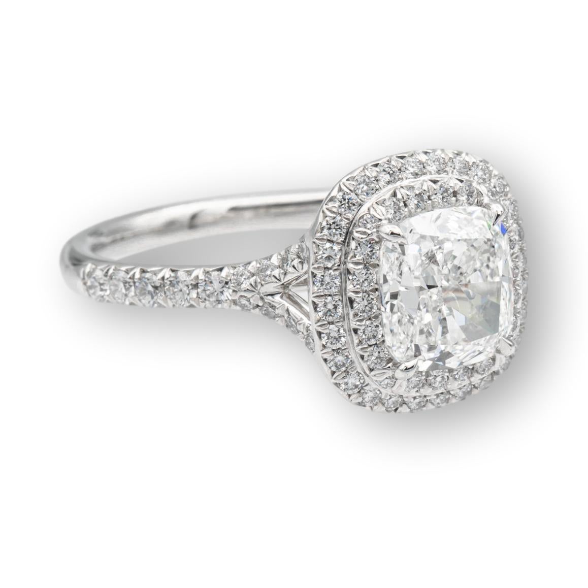 Tiffany & Co. Soleste engagement ring with a 1.56 ct cushion center , I Color, VS1 clarity finely crafted in platinum, accented by a double row halo design with round brilliant cut bead set diamonds weighing 0.36 carats approximately in the D-G