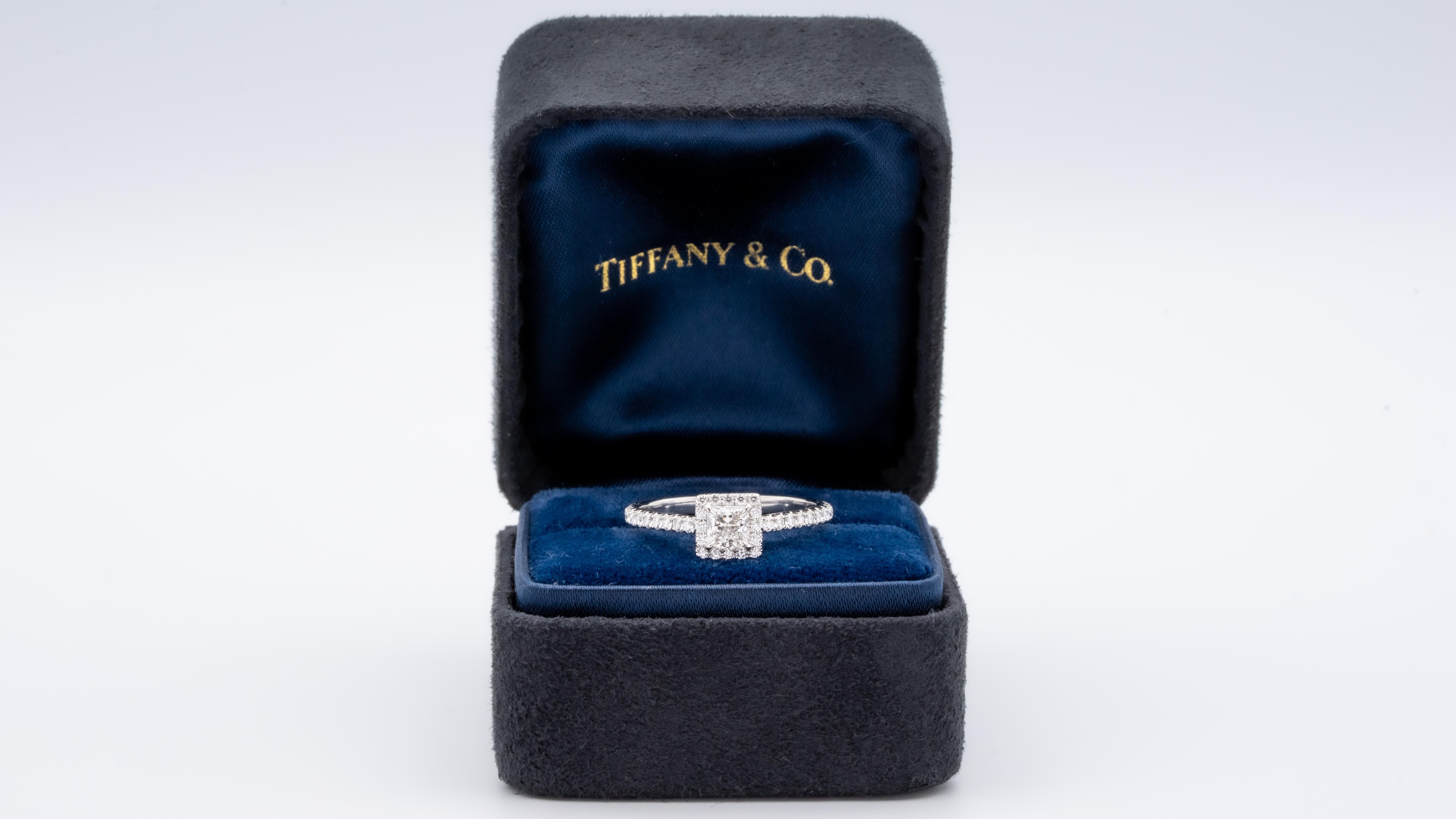 Tiffany & Co. Soleste Diamond Engagement ring featuring a .36 ct Princess Cut Center diamond finely crafted in Platinum, accented by a bead set diamond halo and shank with 36 round brilliant cut diamonds weighing 0.25 cts. total weight for a total