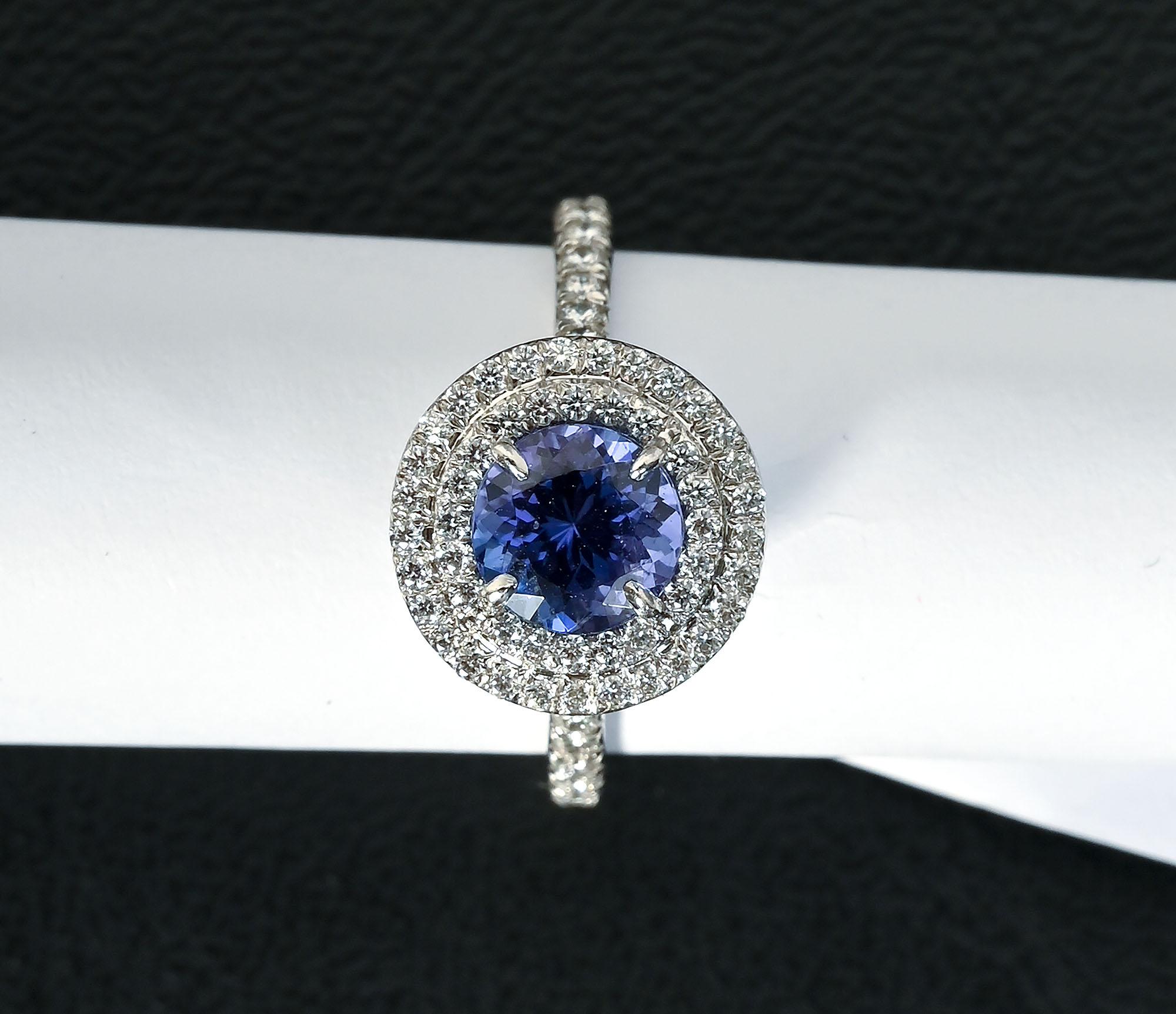 `Graceful and elegant tanzanite and diamond ring by Tiffany from their Soleste Collection. The central tanzanite stone is approximately 1.5 carats. It is surrounded by 2 rows of round brilliant diamonds weighing approximately .45 carats. Diamonds go