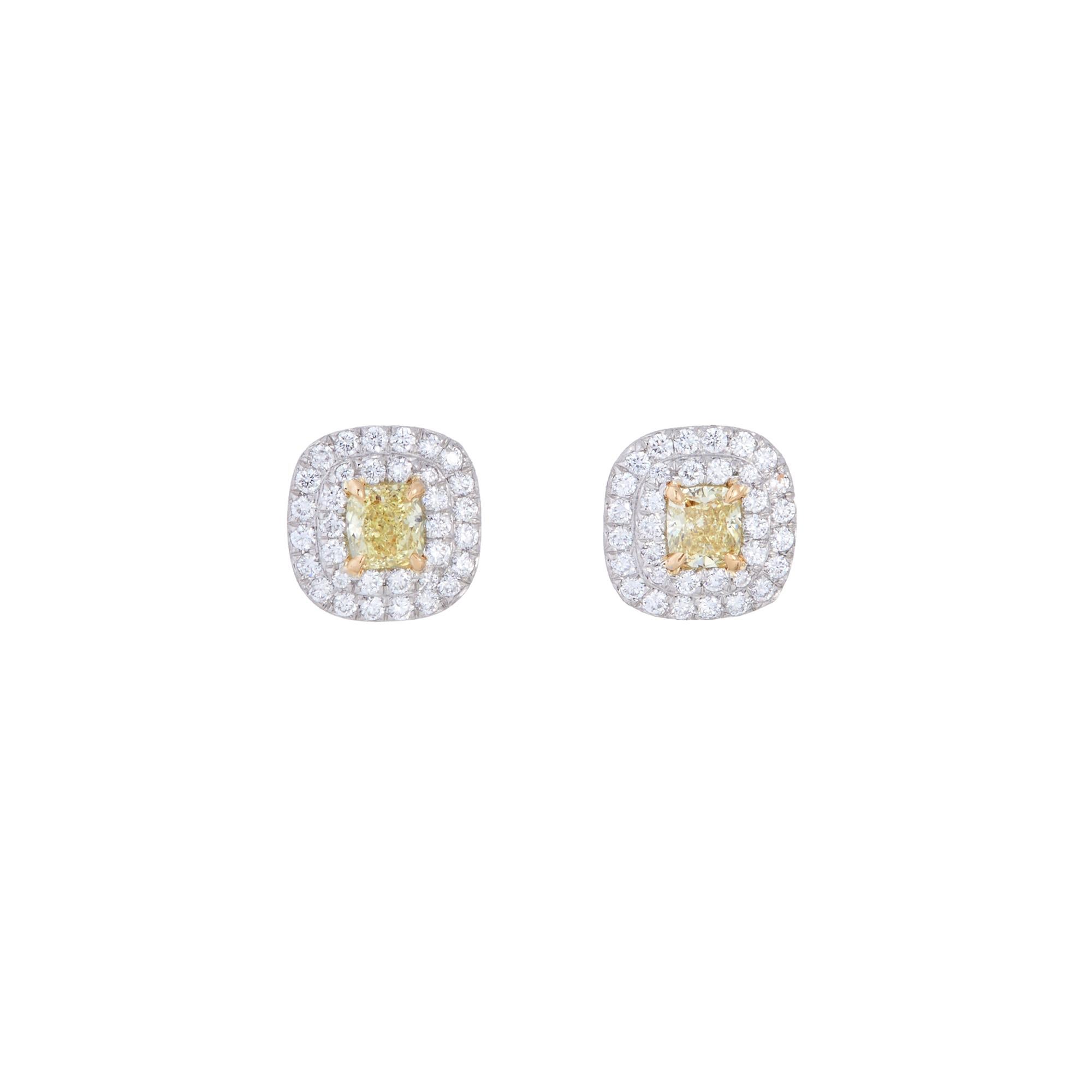 Authentic Tiffany & Co. Soleste earrings crafted in platinum.  Each earring is set with a cushion cut yellow diamond at the center surrounded by a double halo of high quality round brilliant cut diamonds for an estimated total carat weight of 0.66