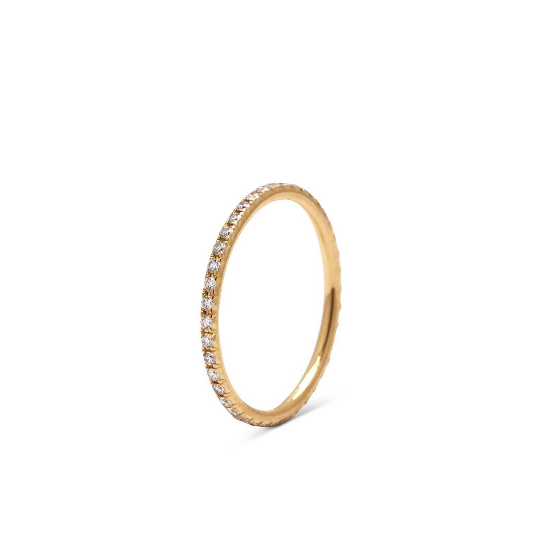 Authentic Tiffany & Co. 'Soleste' eternity band crafted in 18 karat yellow gold and set with approximately 0.42 carats of glittering round brilliant cut diamonds. US Size 5. Signed Tiffany & Co., 750, Belgium. Ring is presented without the original