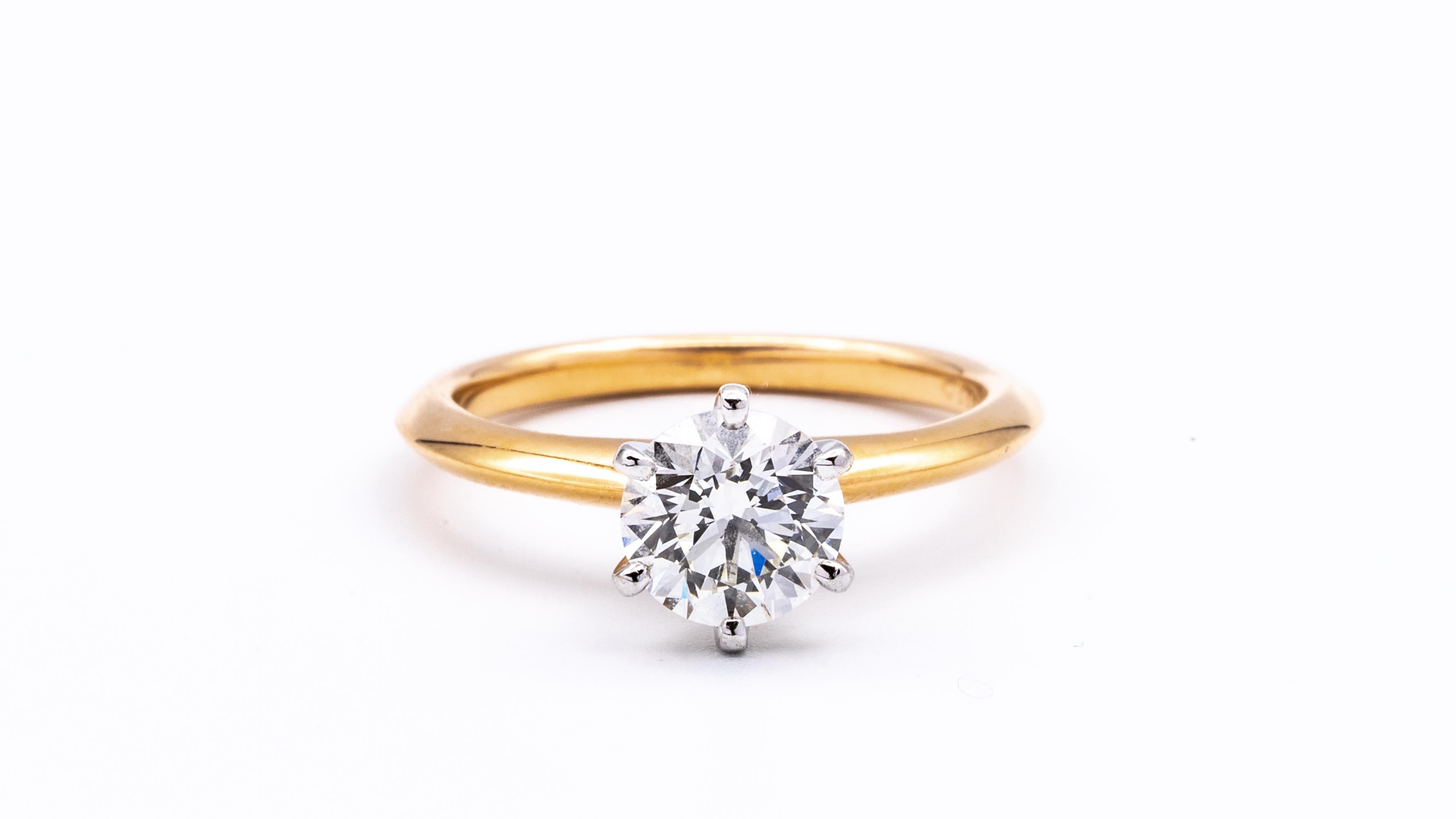 Classic Tiffany & Co Round Brilliant Solitaire Engagement Ring featuring a 1.14 carat Center I color,  VS2 clarity, finely crafted in a 6 prong platinum basket and 18 Karat Rose gold mounting . 
Includes Original Tiffany Certificate and Blue Leather