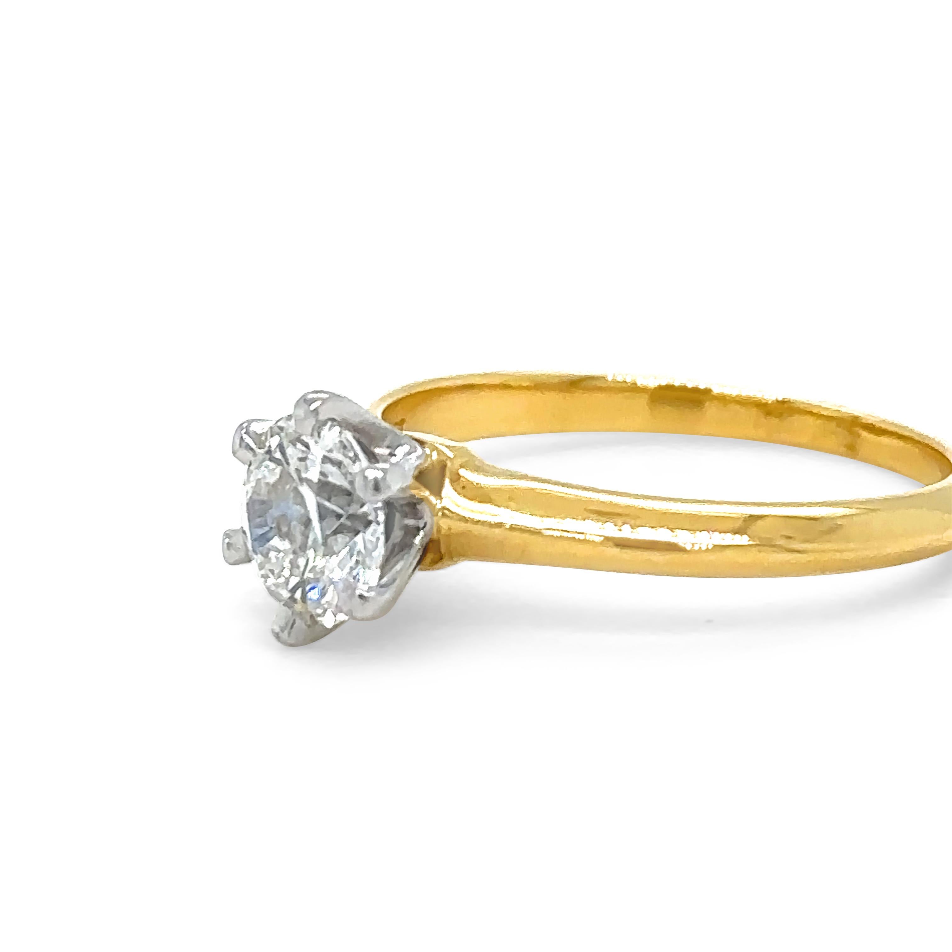 A Tiffany And Co Solitaire Round Brilliant Cut Diamond Ring, six claw set in platinum on 18ct yellow gold 1.6mm knife edge band.

Diamond 0.82ct, Laser engraved number on star facet: F02120284, Serial number on band 18695359.

No Tiffany & Co