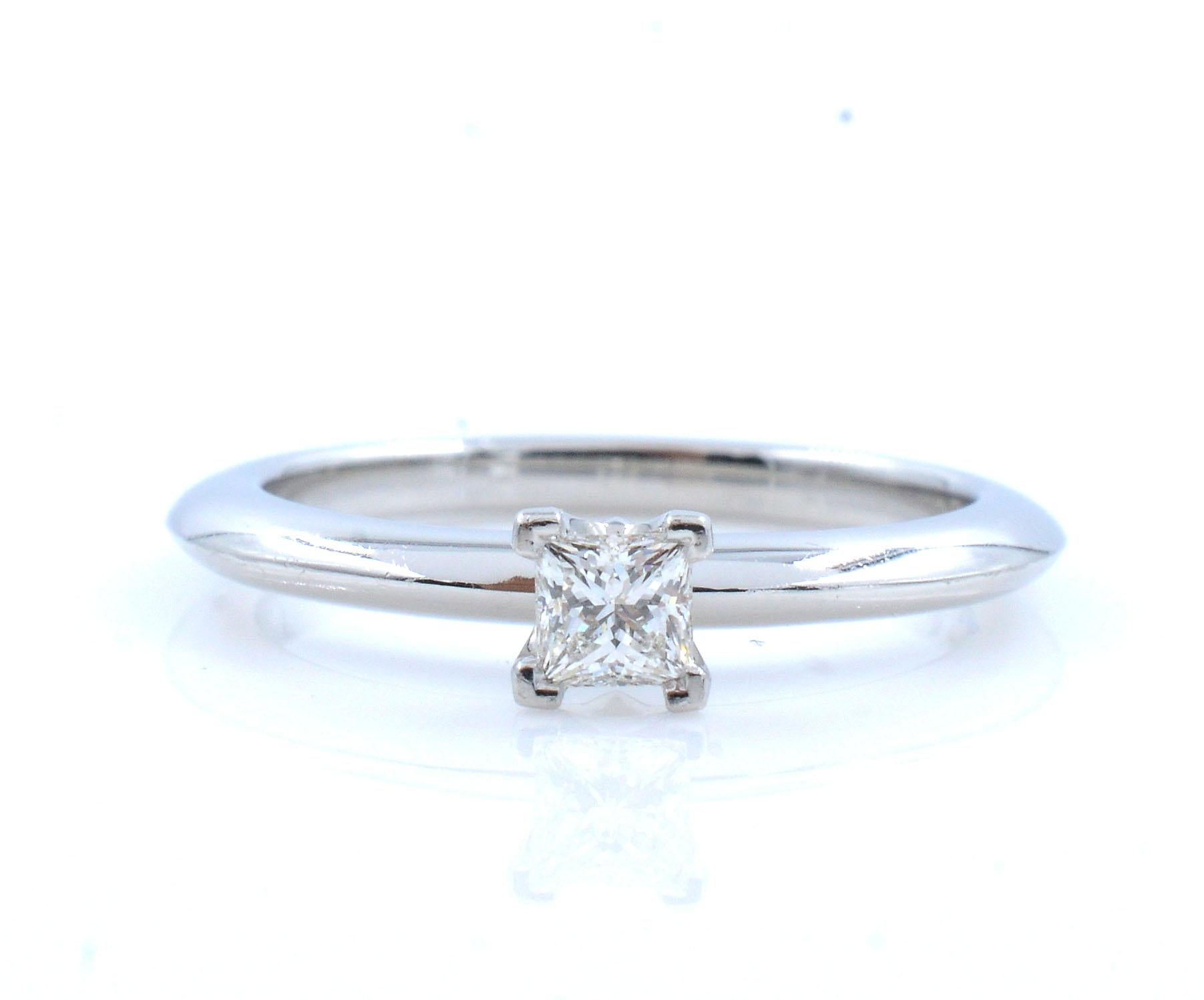 Solitaire ladies diamond engagement ring in Platinum by Tiffany & Co set with princess cut diamond of 0.10cts.
Center diamond G color and VS1 clarity. Pre owned by like new condition. Authentic and hallmarked inside the shank.