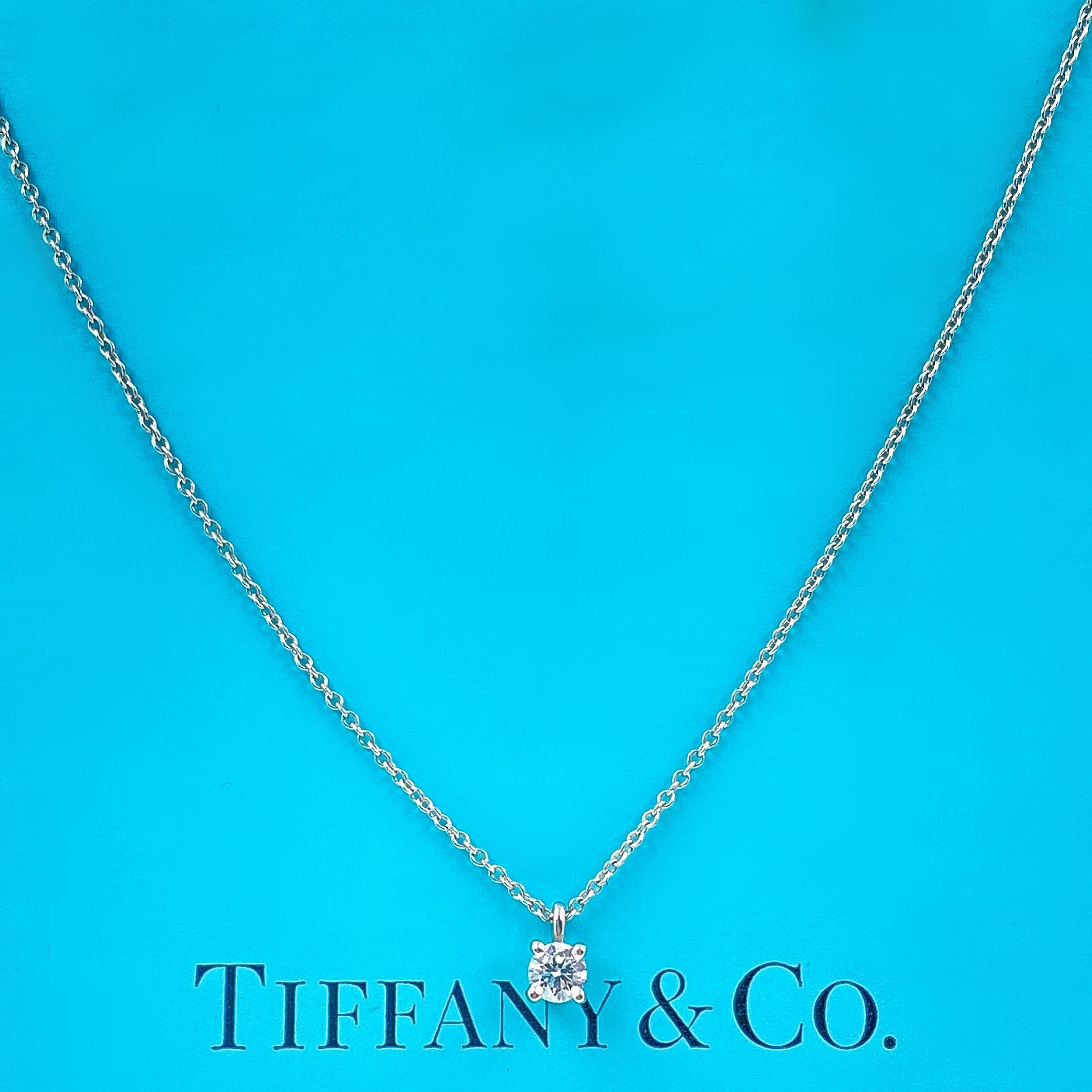Tiffany Solitaire Diamond Pendant
Style:  four-Prong Basket Solitaire
Metal:  PT950 Platinum
Length:  16' Inches
Main Diamond:  Round Brilliant Diamond 0.18 cts
Color & Clarity:  G, VVS
Hallmark:  ©TIFFANY&CO. PT950
Includes:  T&C Microsuede Pendant
