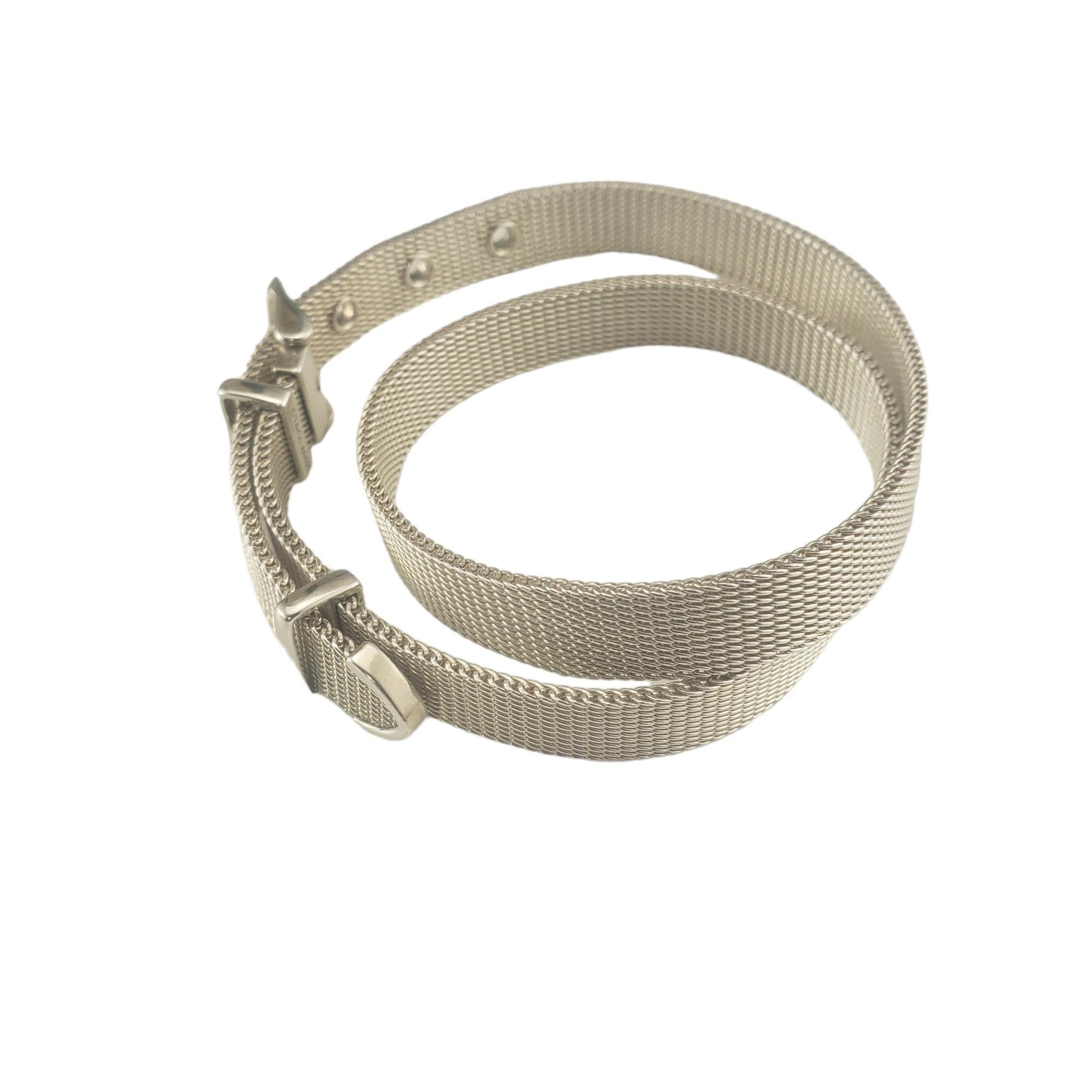 Tiffany & Co. Somerset Double Wrap Sterling Bracelet- 

This elegant double wrap mesh bracelet is crafted in beautifully detailed sterling silver by Tiffany & Co.  Secured with an adjustable buckle.

*Slight bend noted in mesh due to