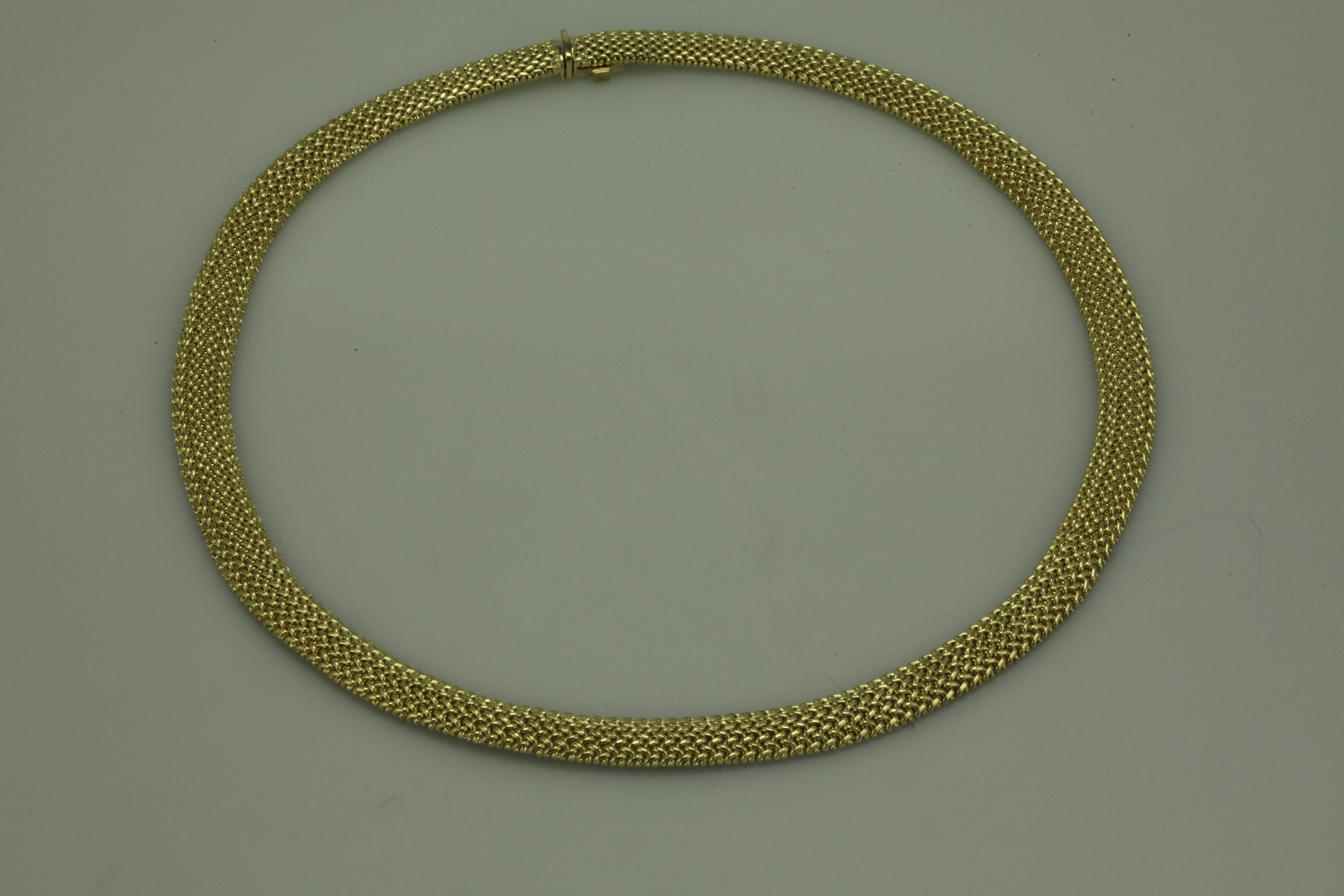 Tiffany & Co Somerset Mesh Necklace made in 18k yellow gold.  This mesh flexible necklace is 10mm wide and 19.5 inches in length.  This necklace features a locking box clasp. This gorgeous authentic 
choker is stamped with Tiffany &co trademark.