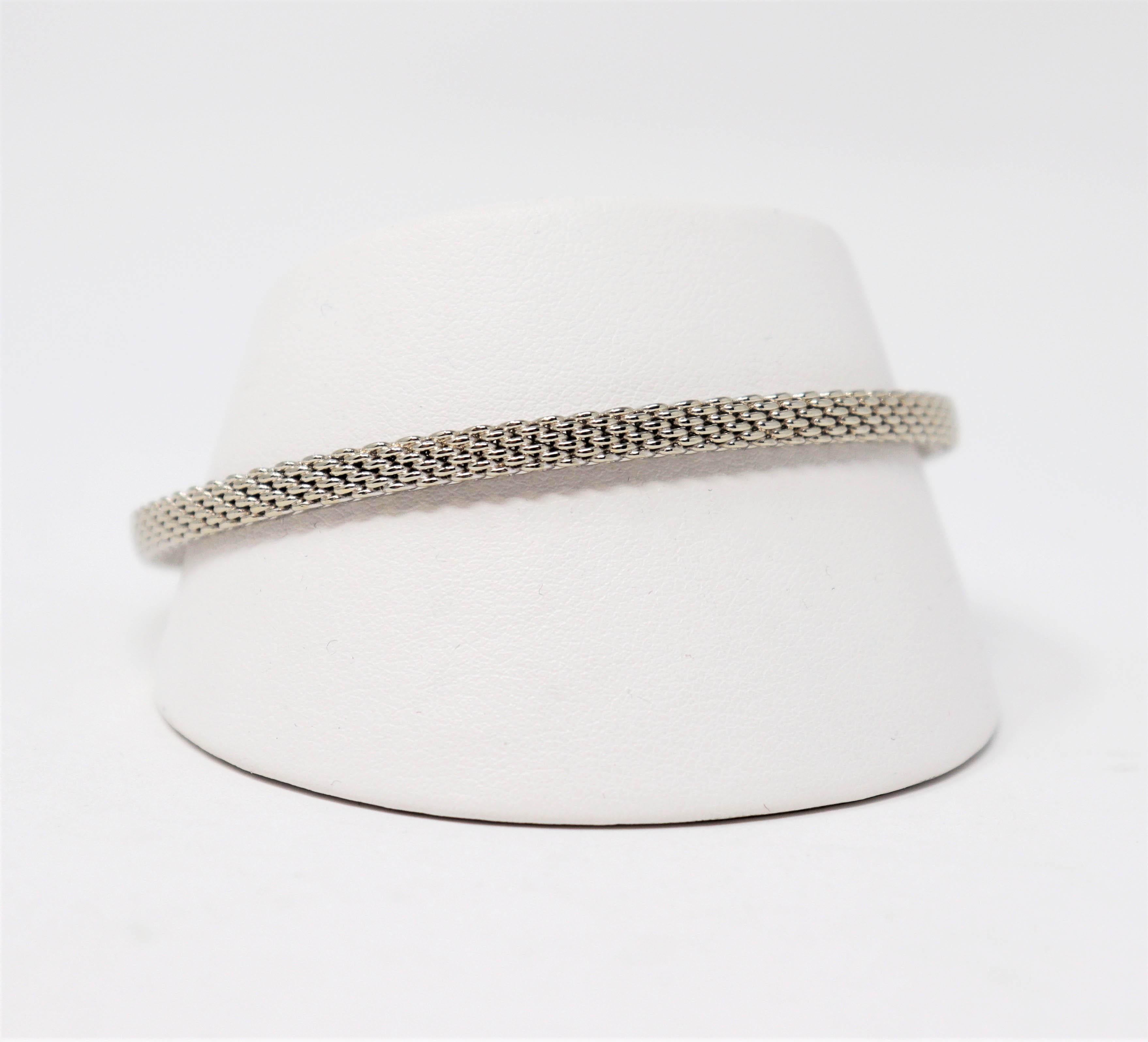 Simple yet stunning Somerset mesh bracelet by renowned jeweler, Tiffany & Co. The rigid woven bangle boasts a sophisticated feel, while the classic simplicity gives it a timeless elegance.

The Somerset bracelet features an ultra fine, structured