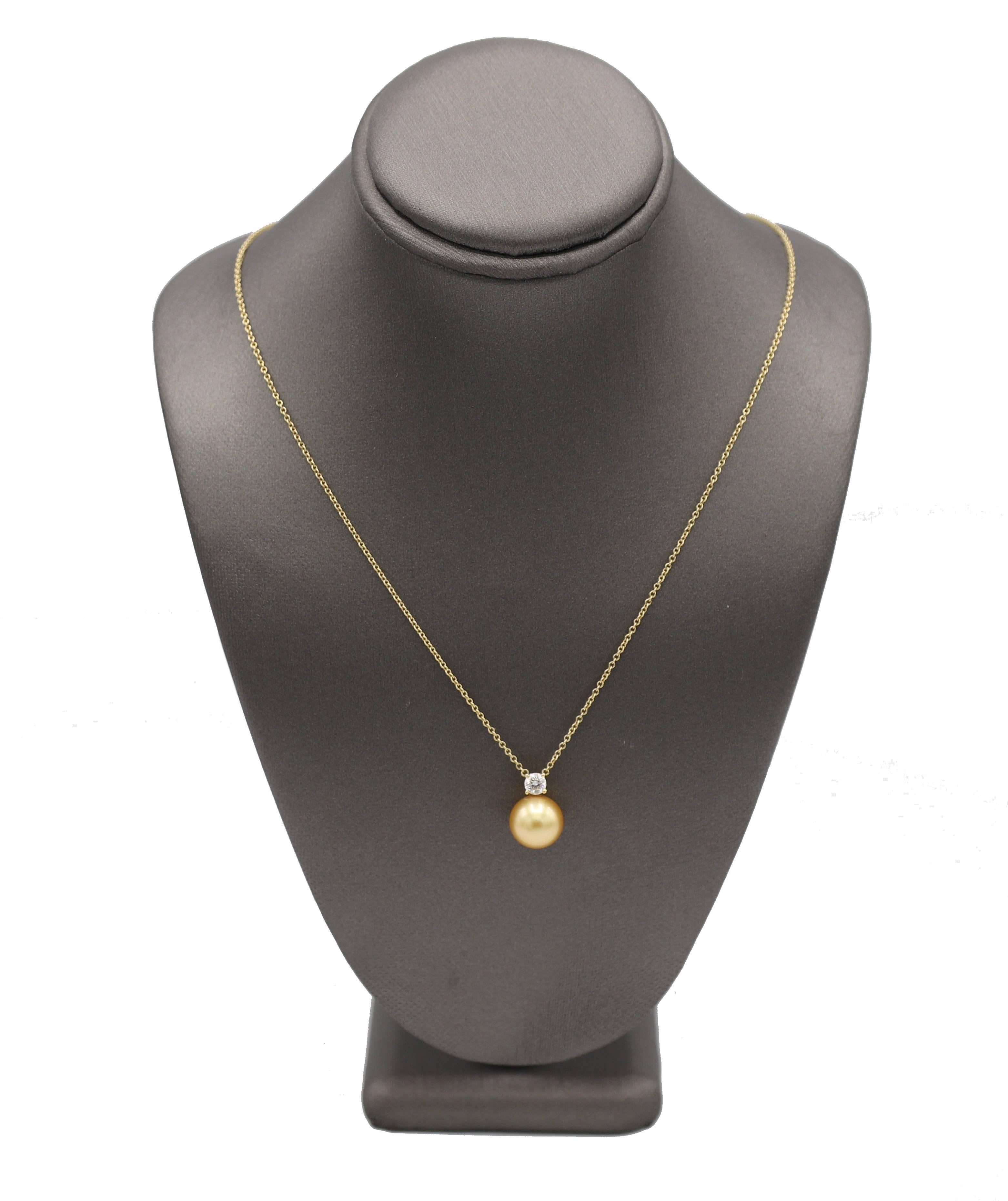 Tiffany & Co. South Sea Golden Yellow Pearl & Natural Diamond Pendant Drop Necklace 

Metal: 18k yellow gold
Weight: 2.94 grams
Diamond: 0.17 carat round F VS natural diamond
Pearl: South Sea golden yellow pearl, 9.3mm
Length: 16 inches
Signed: