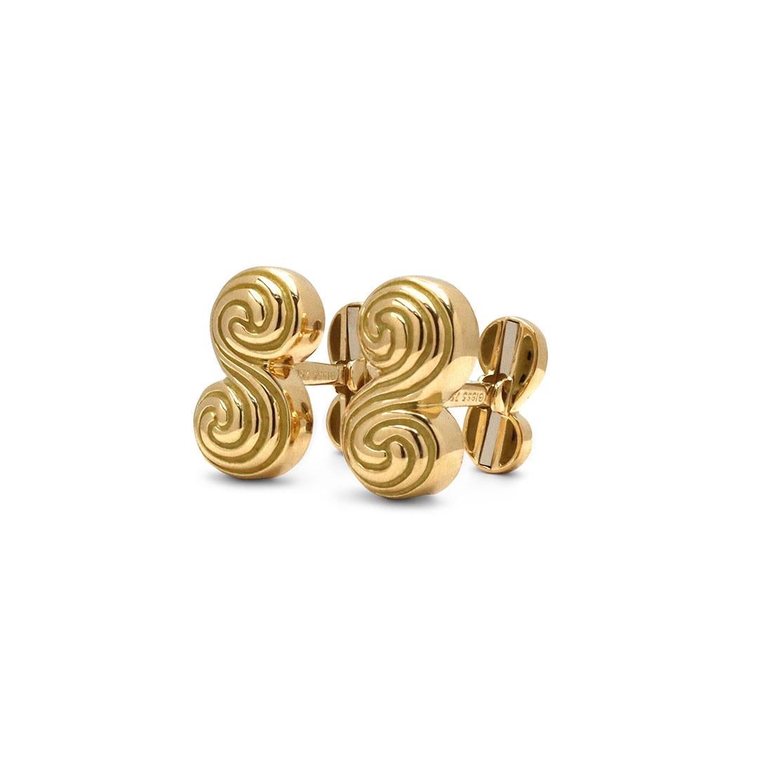 Authentic Tiffany & Co. Spiro Swirl cufflinks crafted in 18 karat yellow gold. These classic cufflinks are designed with deep grooves in the form of the letter S. Signed Tiffany & Co., 750. The cufflinks are presented with Tiffany & Co. pouch, the