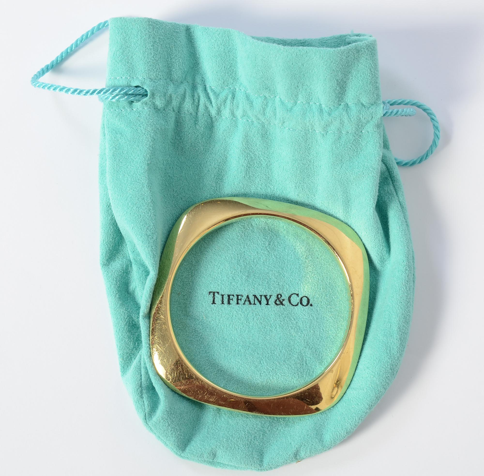 Wonderful Modernist design 18 karat gold bangle bracelet by Tiffany. The square bracelet has rounded edges and a round interior that measures 2 9/16