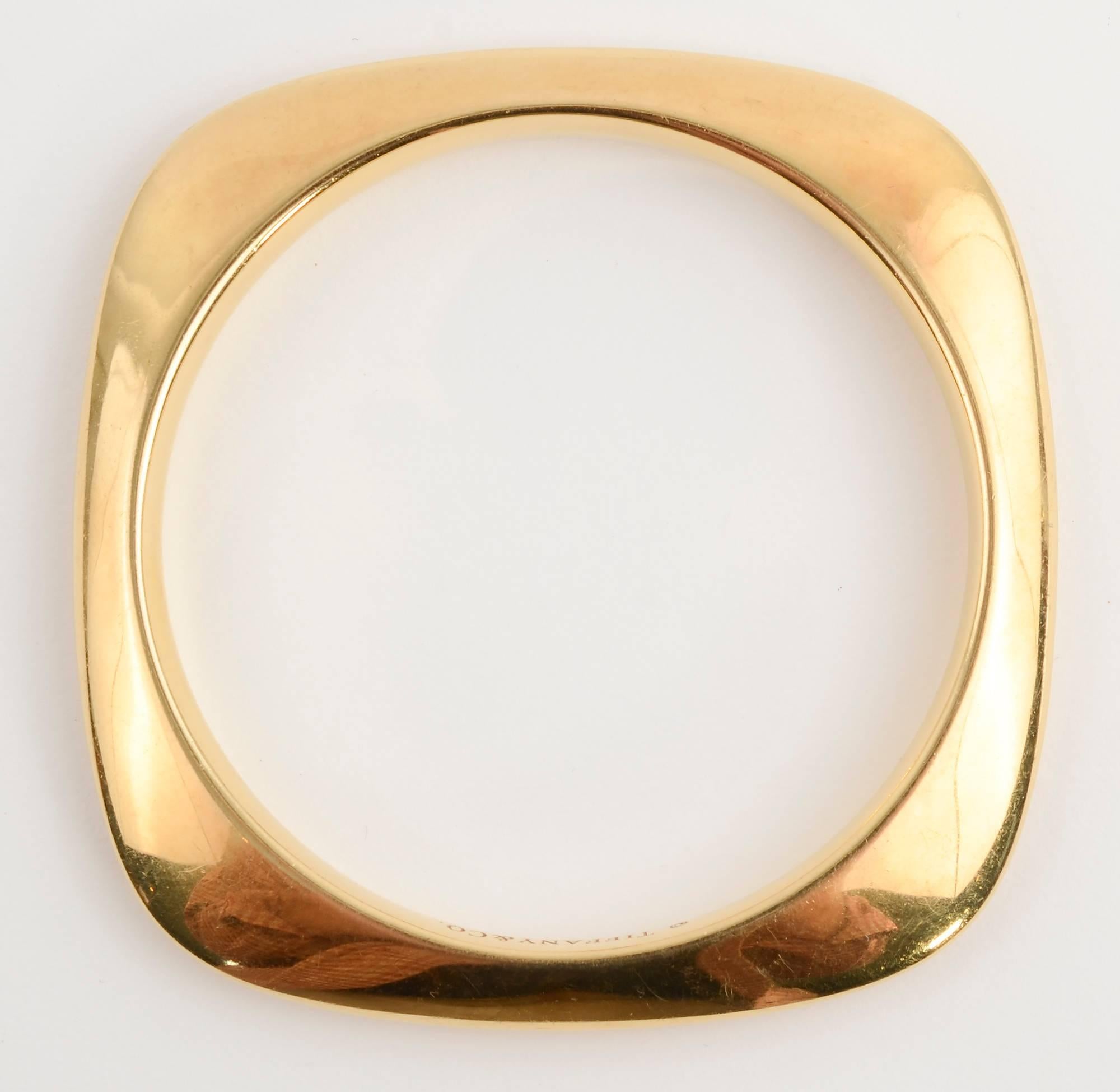 Wonderful modernist design 18 karat gold bangle bracelet by Tiffany and Co.
The square bracelet has rounded edges and a round interior that is 2 5/8 inches in diameter. It fits a medium wrist. 