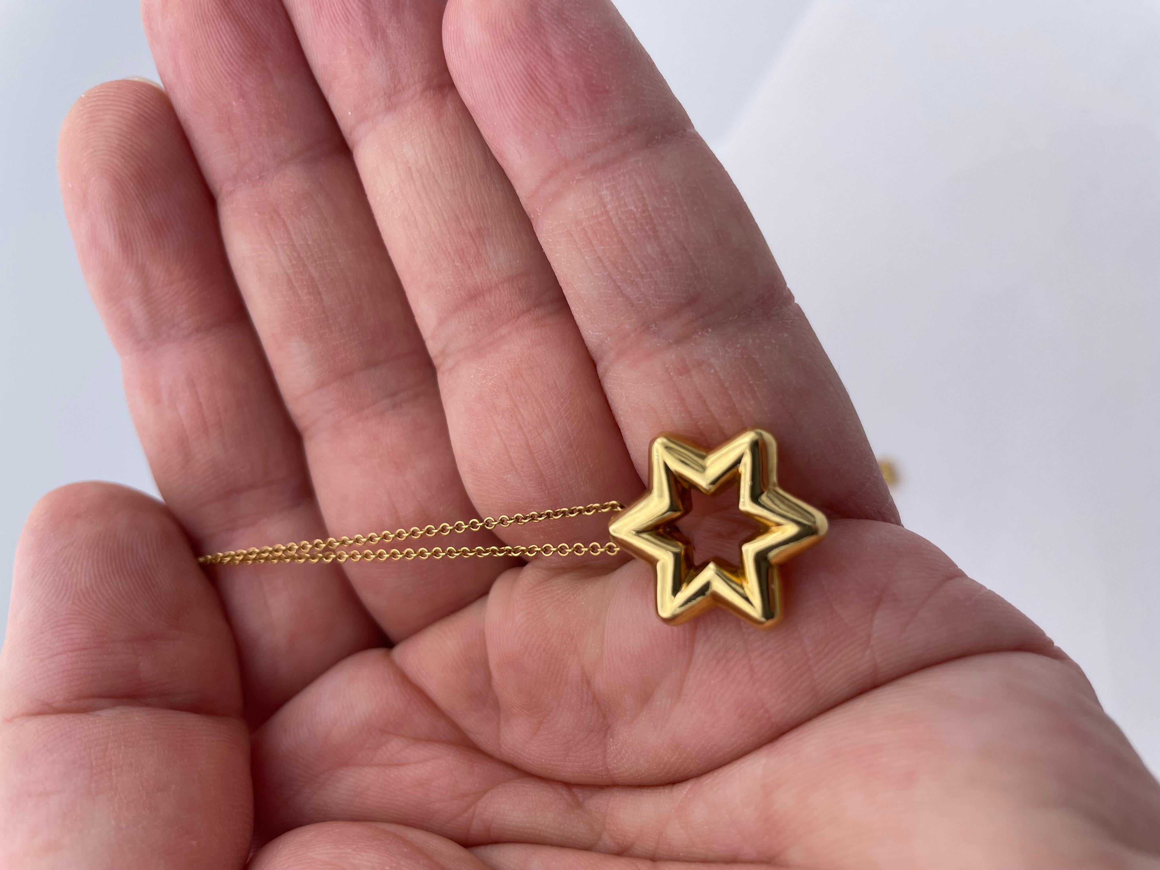 Lovely Star of David.  Made and signed by TIFFANY & CO.  Solid gauge 18K yellow gold, set with four diamonds.  1/2