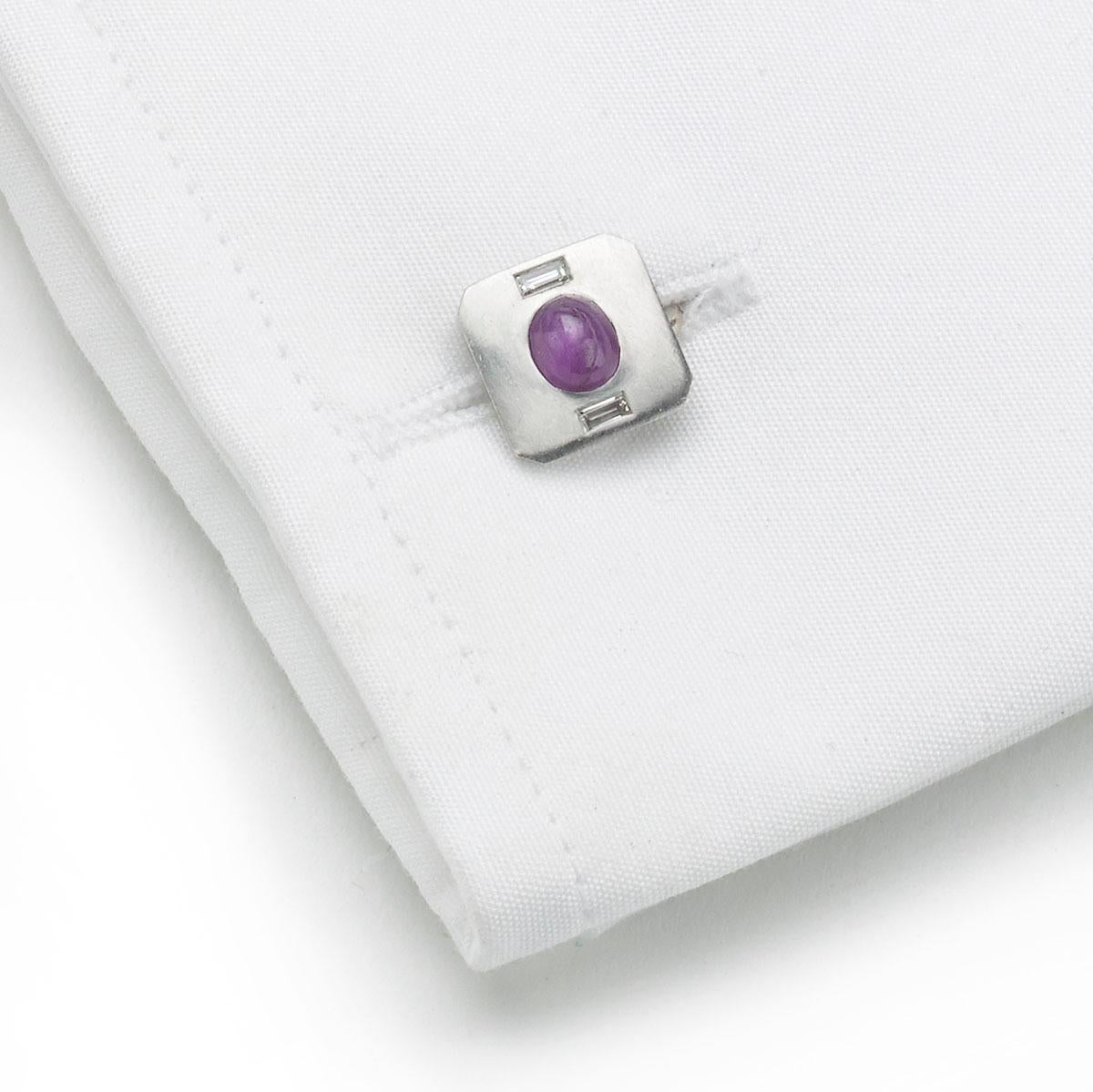 A Tiffany & Co., vintage, ruby and diamond dress-set, comprising of a pair of cufflinks and three dress studs, each set with an oval cabochon star ruby, in the centre of platinum squares, with cut corners, the cufflinks have a baguette-cut diamond
