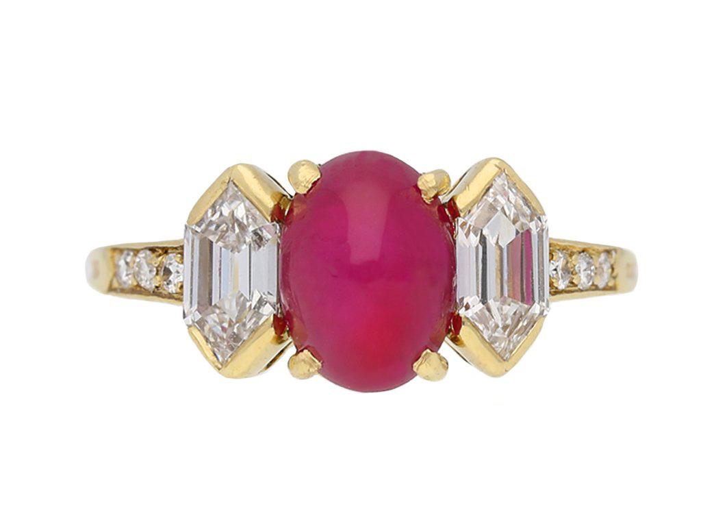 Vintage star ruby and diamond ring by Tiffany & Co. Set centrally with an oval cabochon natural unenhanced Burmese star ruby in an open back claw setting with an approximate weight of 2.47 carats, flanked by two hexagonal step cut diamonds in open