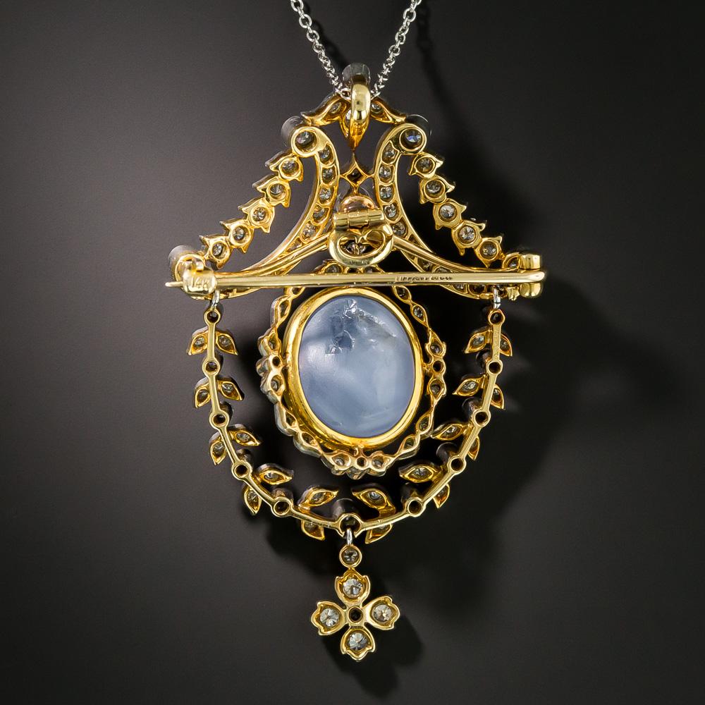 A superb and extravagant early 20th century work of art from Tiffany & Co. A large and luminous periwinkle blue cabochon star sapphire, weighing 25 carats and set in a gold bezel, floats in a surround of glittering diamonds and suspends from an