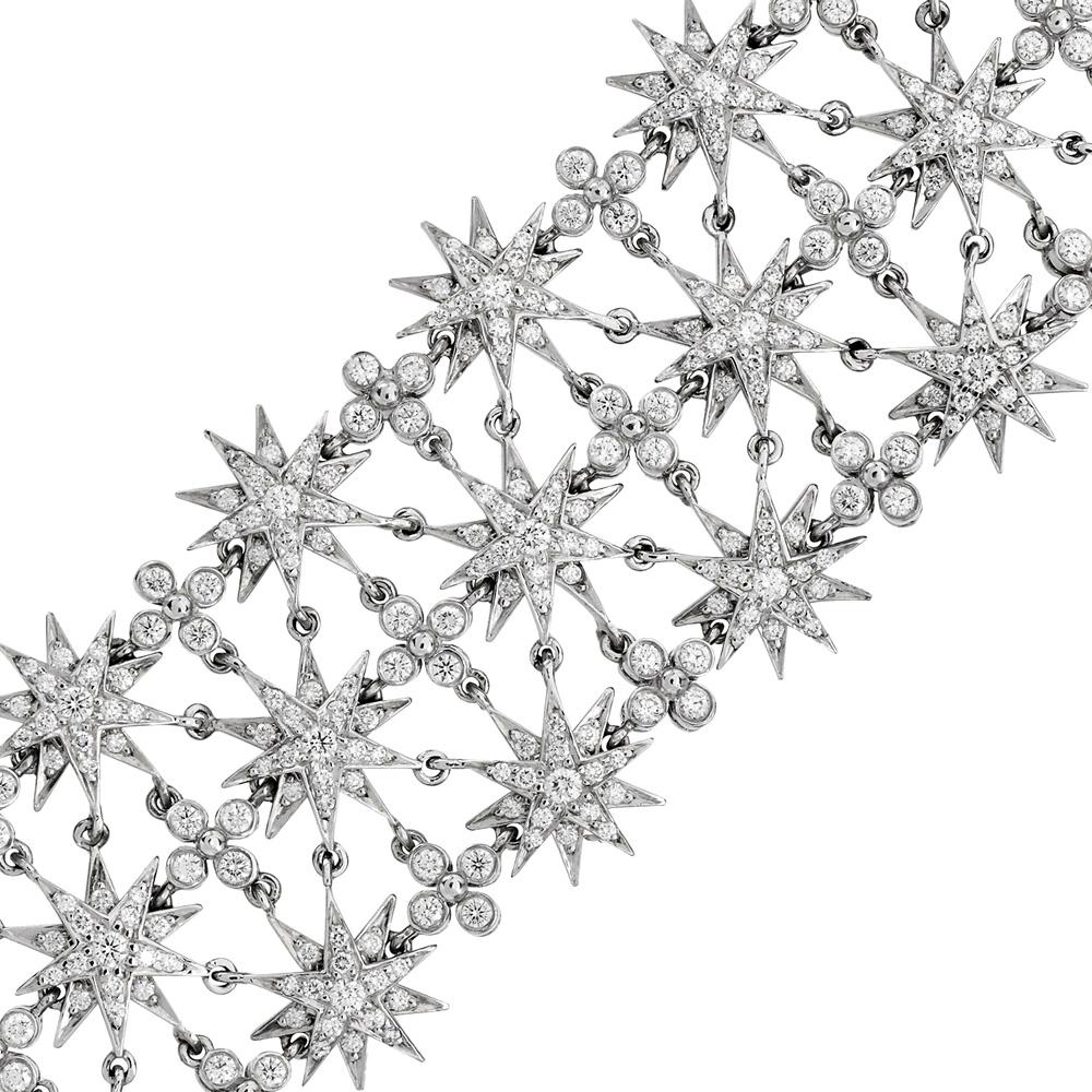 This dazzling Tiffany & Co. Starburst Bracelet, crafted in platinum, the bracelet features three rows of diamond-set starburst motifs interlinked with bezel-set diamond quatrefoil accents. A total of approximately 6.02 carats of round brilliant