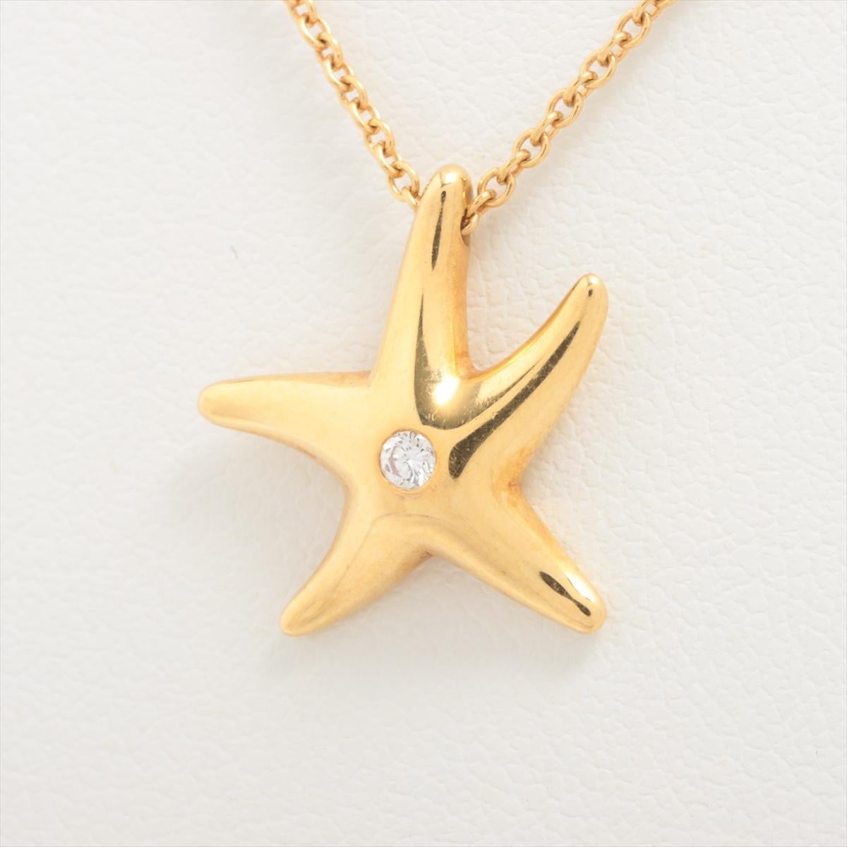 The Tiffany & Co. Starfish Diamond Pendant Necklace in Gold a captivating and elegant accessory that evokes the beauty of the sea. Meticulously crafted by Tiffany & Co., the necklace features a delicate starfish pendant adorned with a single