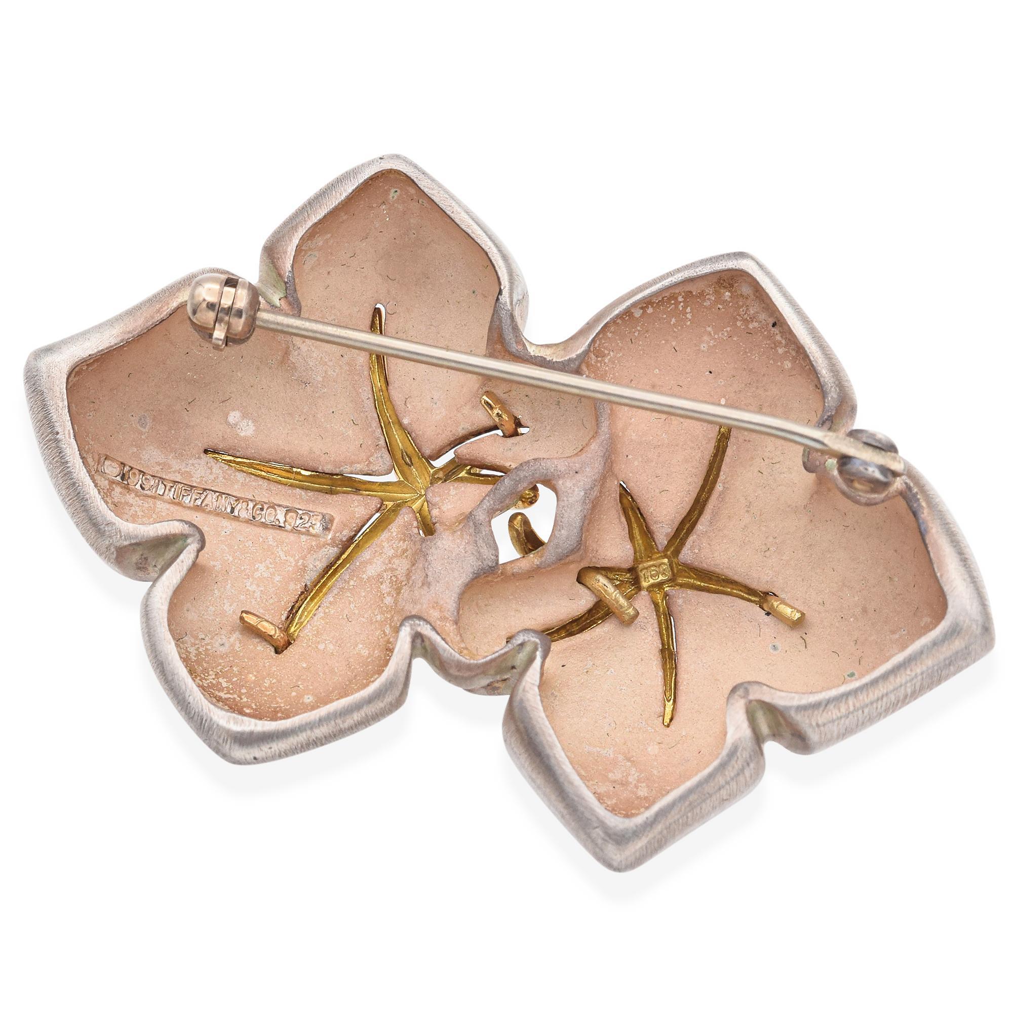 Elegant Tiffany & Co. 1999 Brooch in 18K Gold and Sterling Silver. This exquisite piece features two sterling silver signature Starfish design adorned with delicate 18k gold accents. The brooch showcases a harmonious blend of metals, creating a