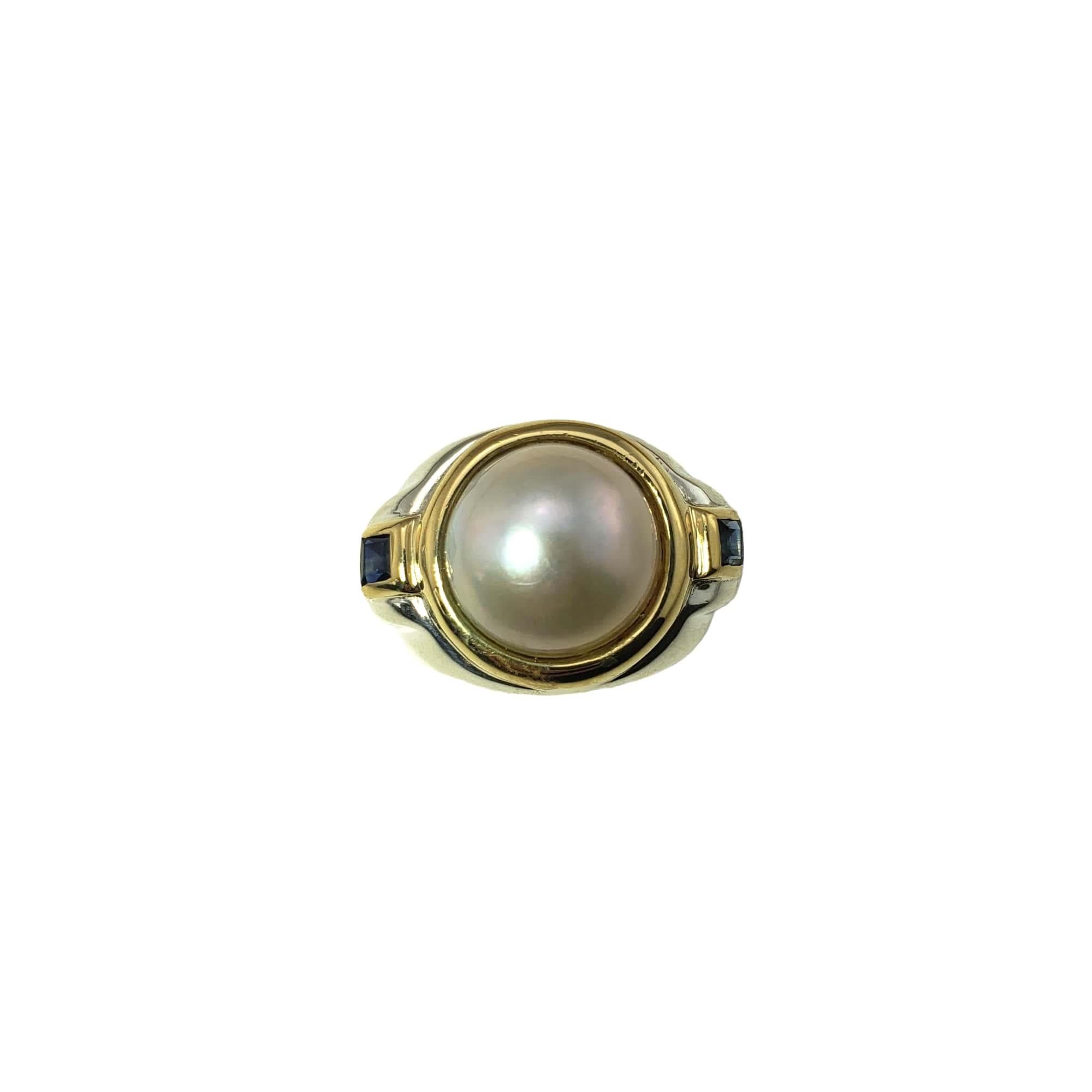 Vintage Tiffany & Co. Sterling Silver and 18 Karat Yellow Gold Mabe Pearl and Sapphire Ring Size 5.75-

This lovely ring by Tiffany & Co. features one Mabe pearl (12 mm) and two square sapphires set in sterling silver and 18K yellow gold. Width: 17