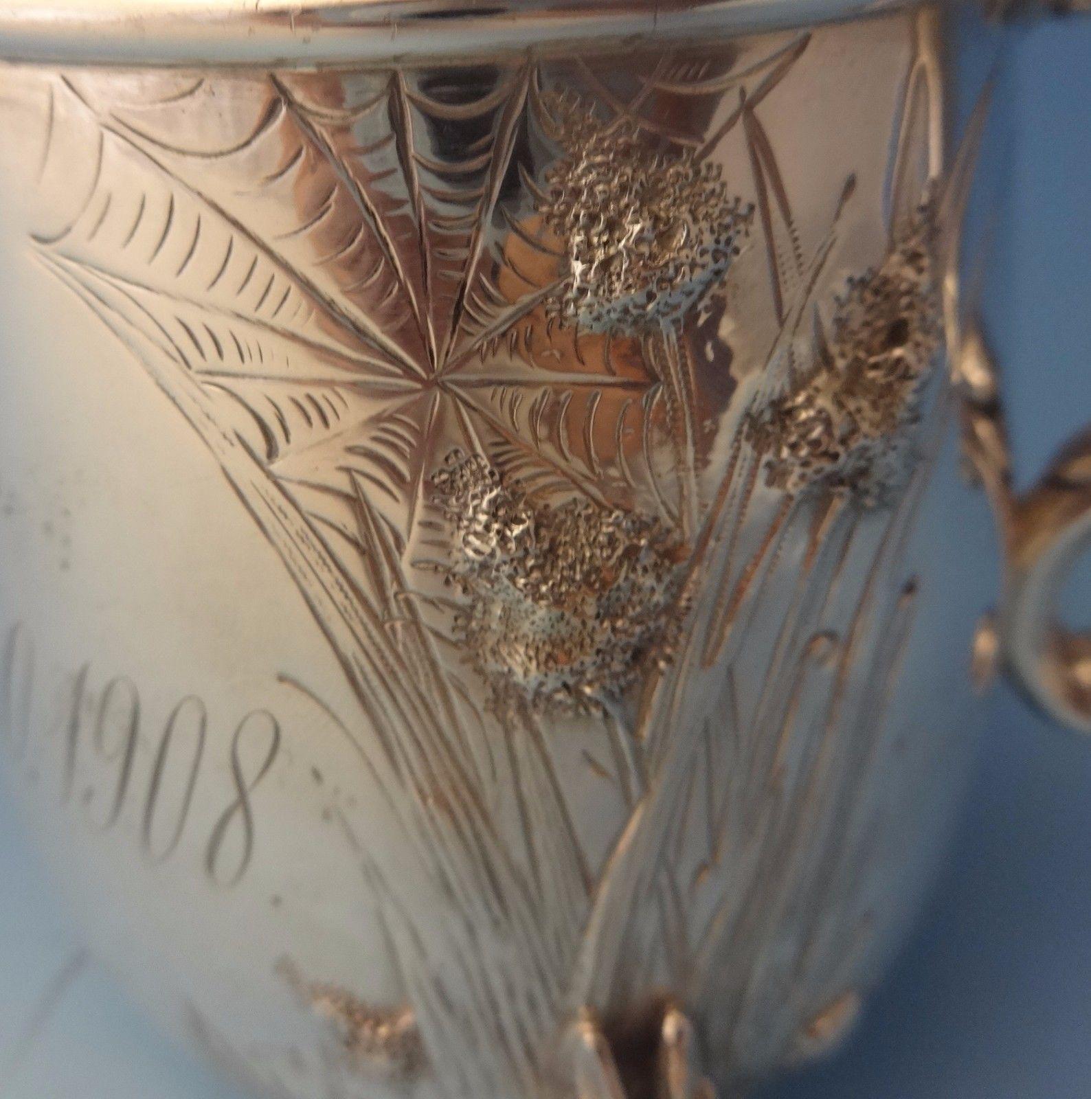 Tiffany & Co.This fine sterling baby cup was made by Tiffany & Co. featuring 3-D rabbits as the feet. It is repoussed and chased with grasses and foliage. There is also a bright cut spider web. It has a gold washed interior. The piece is monogrammed