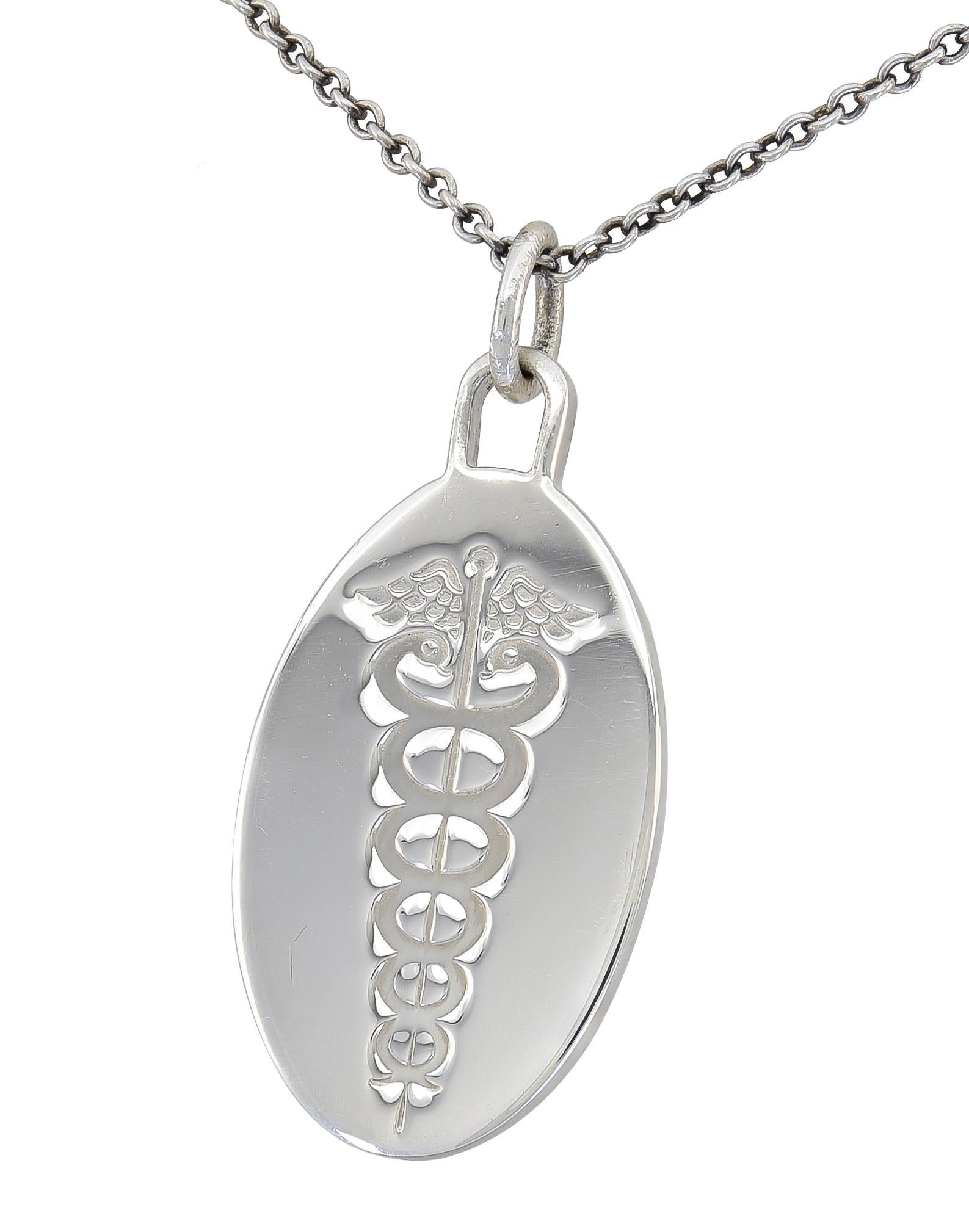 Oval sterling silver pendant/charm with large engraved caduceus.  Made and signed by TIFFANY & Co.  2/3
