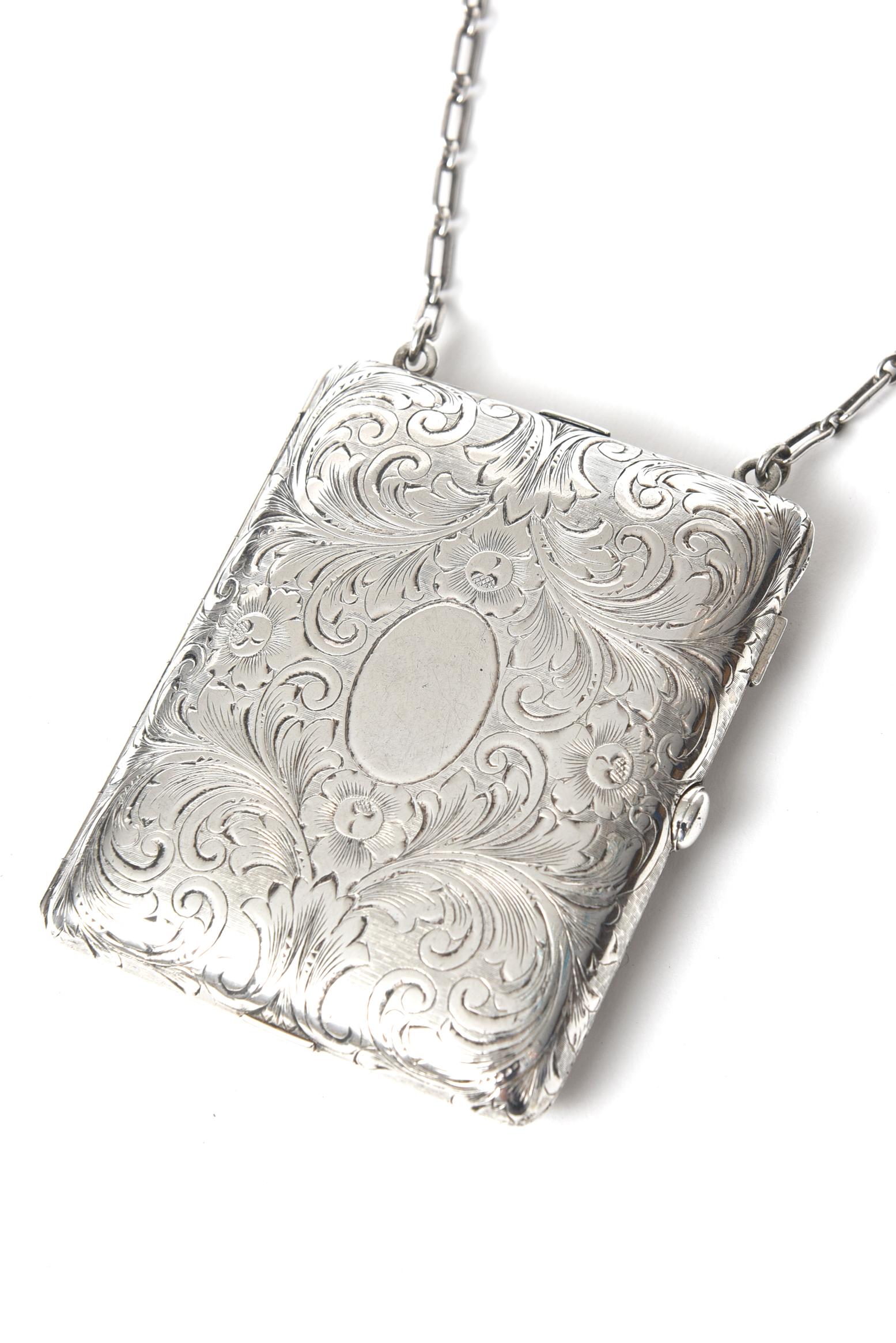 Early 20th century Tiffany & Co. sterling silver compact purse. This piece has a mechanical pencil, an area for cards, a mirror and a section for powder and rouge. No monogram and is new old stock; part of a collection from a jewelry store that