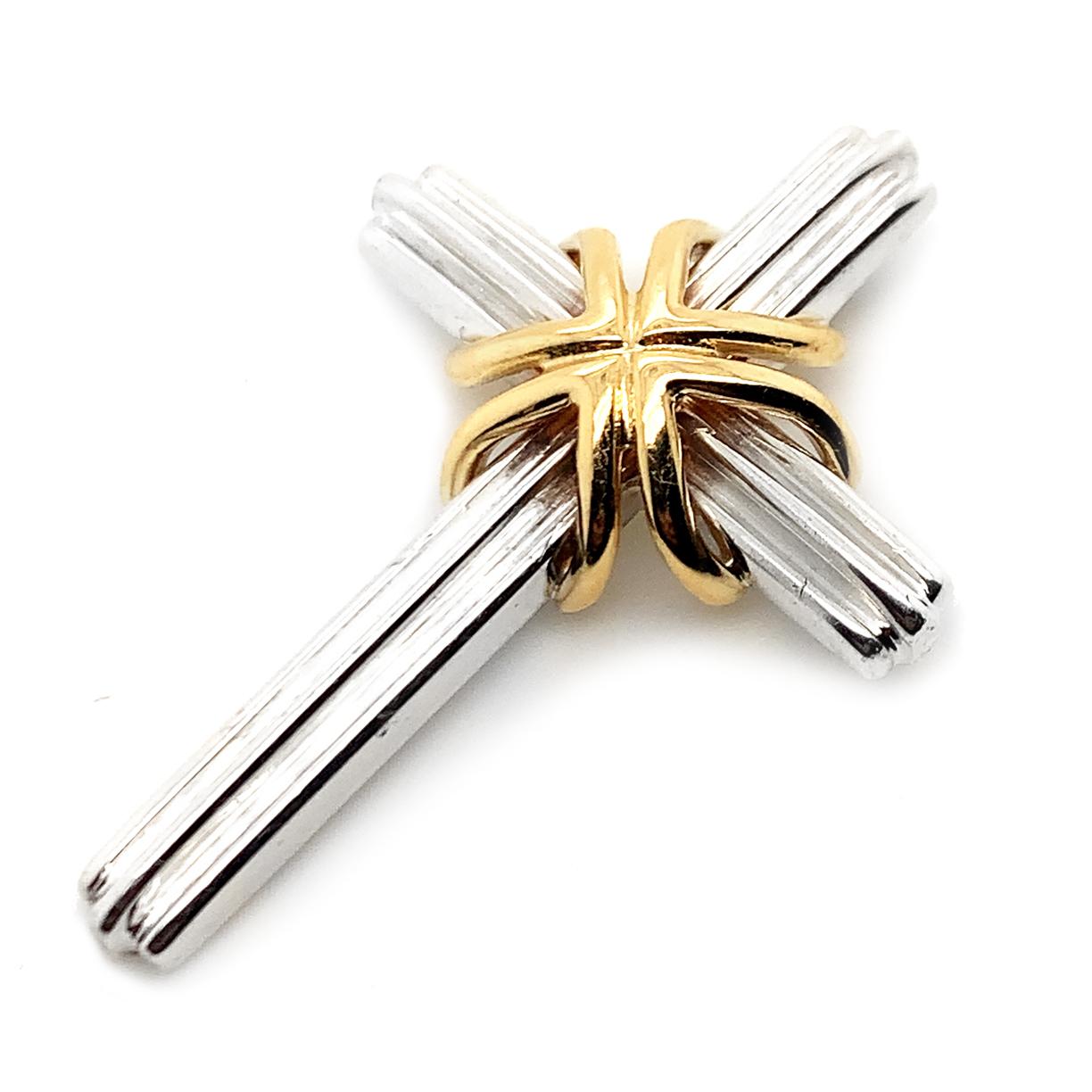 Sterling silver cross with aa three-dimensional applied 18K gold double band.    Made and signed by TIFFANY & CO.  Fluted pattern.  
.88