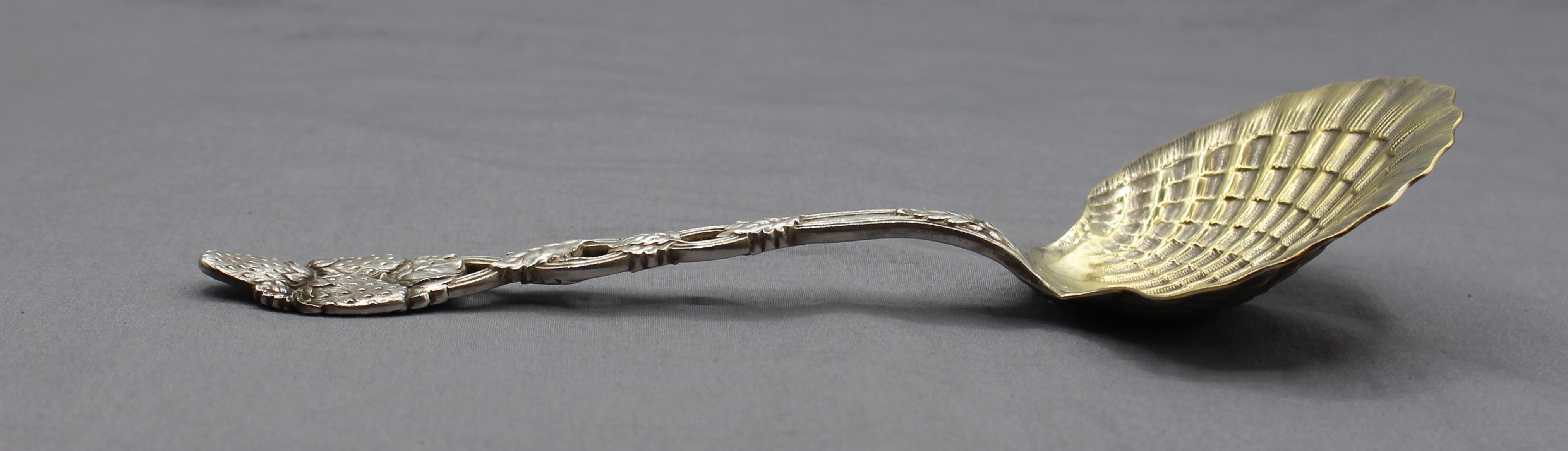Tiffany & Co sterling & gold washed Strawberry Vine pattern serving spoon. The large scallop shell bowl accented by vine entwined handle with a trio of strawberries. Never engraved. Marked Tiffany & Co, Sterling. 4.15 troy oz. 
8 7/8