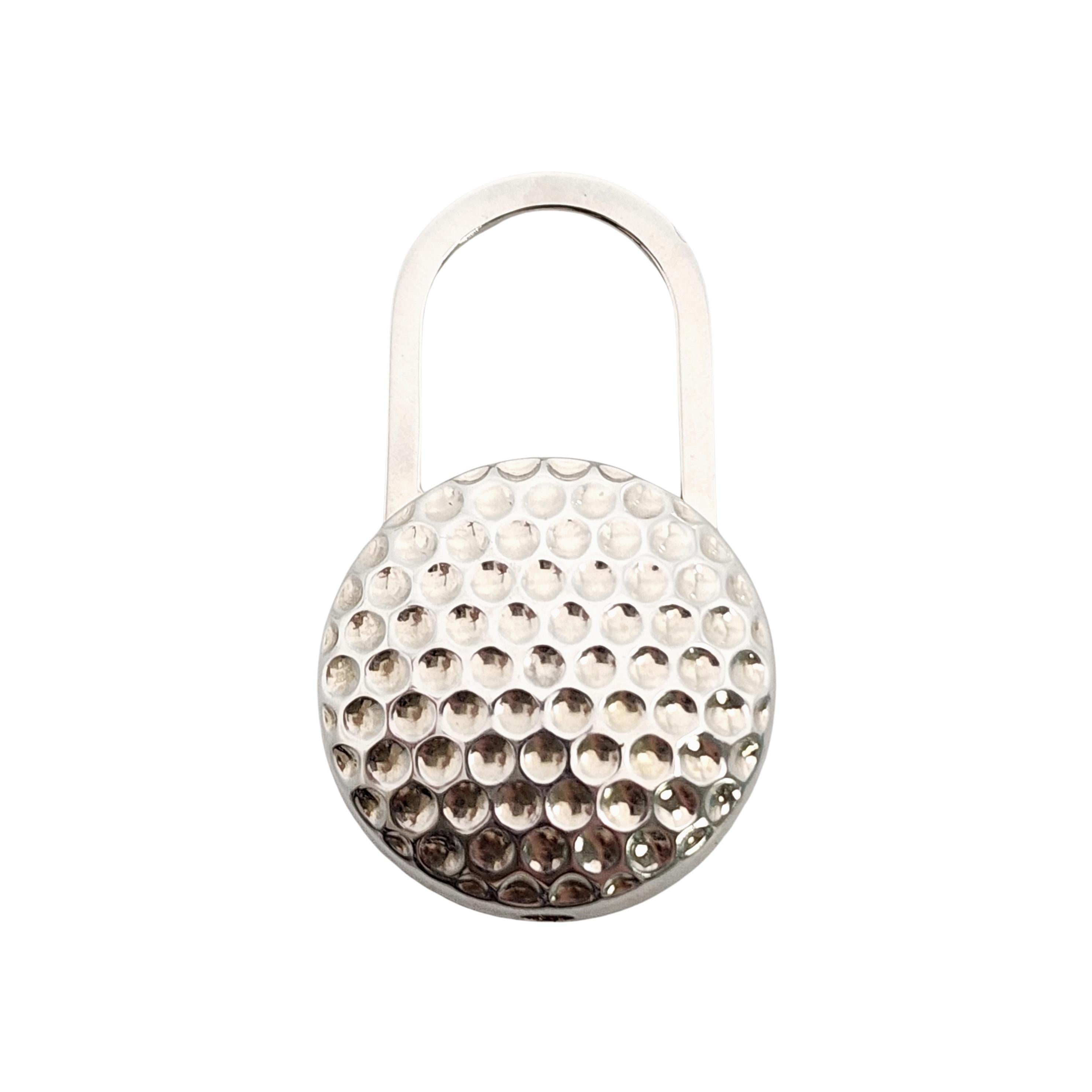Sterling silver golf ball padlock key ring by Tiffany & Co with pouch and box.

A classic padlock design featuring a detailed golf ball. Pull up and twist to add keys. Tiffany box and pouch are included.

Measures approx 2 1/8