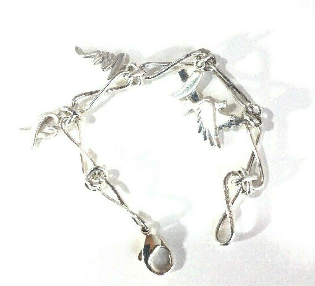 Tiffany & Co Sterling Paloma Picasso Charm Bracelet Dove Heart Kiss Scribble

This is a stunning sterling silver four charm bracelet designed by Paloma Picasso, Tiffany & Co.  The bracelet features a dove, heart, kiss and scribble