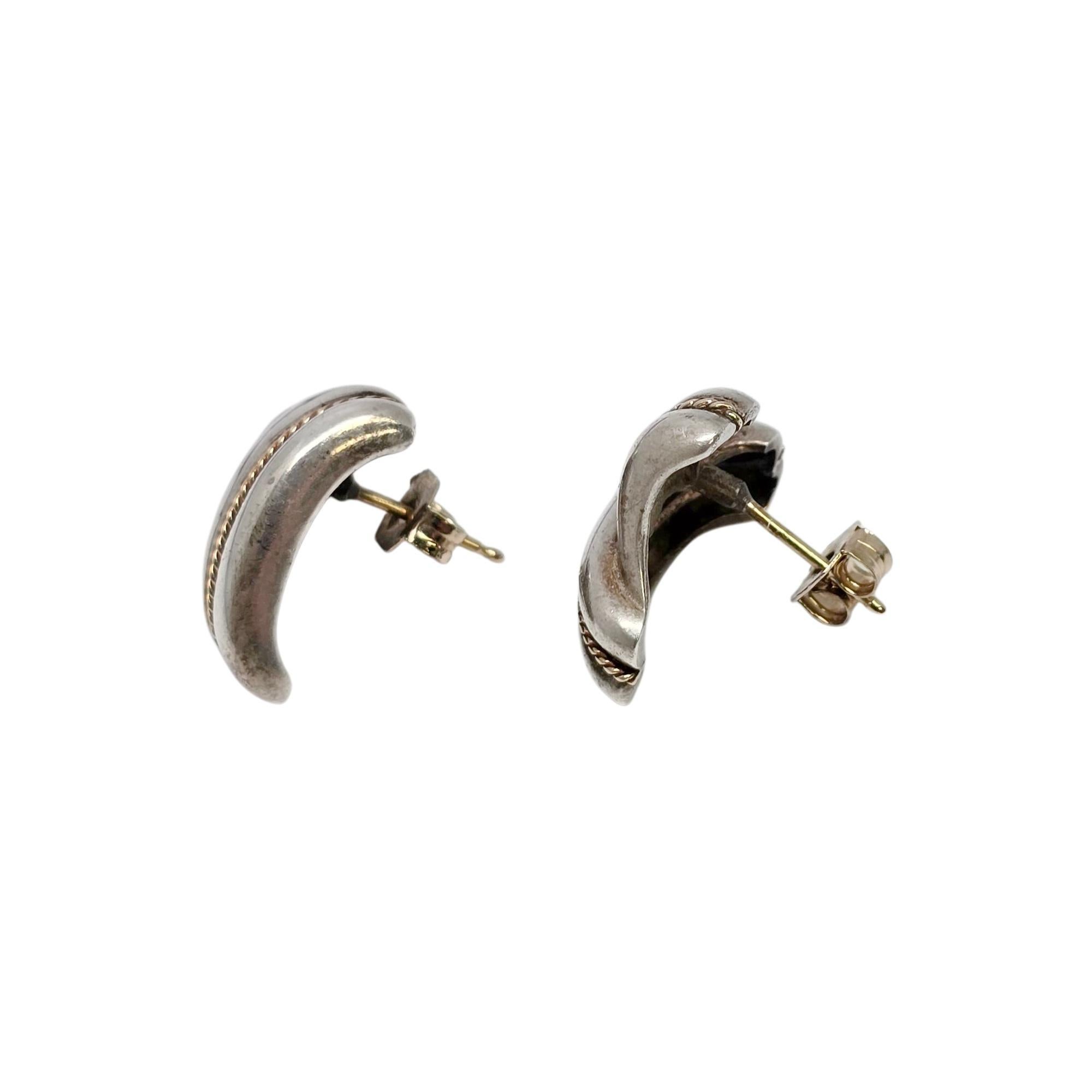 Sterling silver 14K yellow gold rope accent crossover earrings by Tiffany & Co.

A pair of authentic Tiffany earrings in a crossover V design featuring yellow gold rope accents. Gold posts. Back are NOT Tiffany. Tiffany & Co box and pouch are not