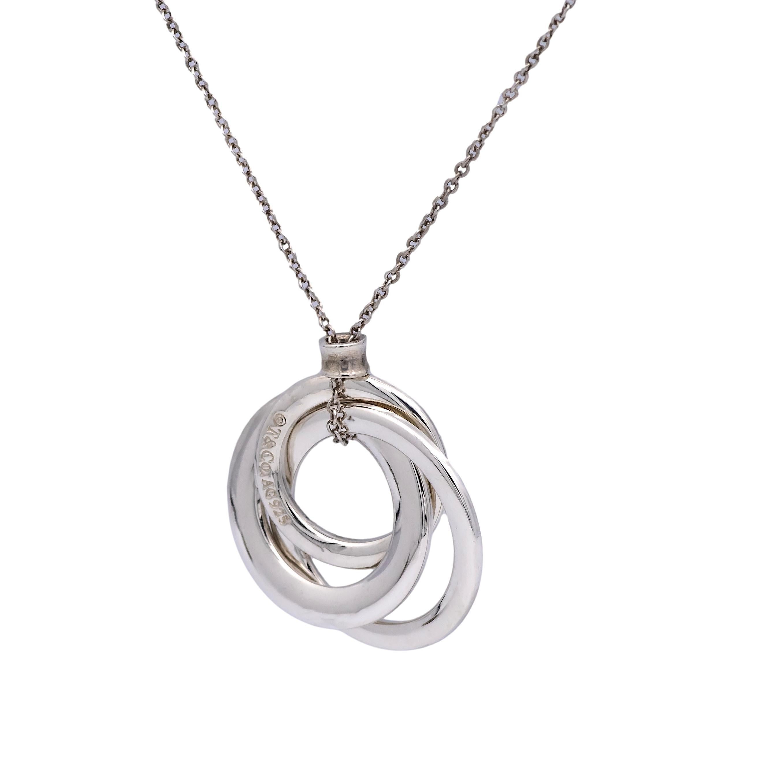 Tiffany & Co. silver necklace from the 1837 Circles collection finely crafted in sterling silver featuring three interlocking open circles hanging off a thin round link chain measuring 18